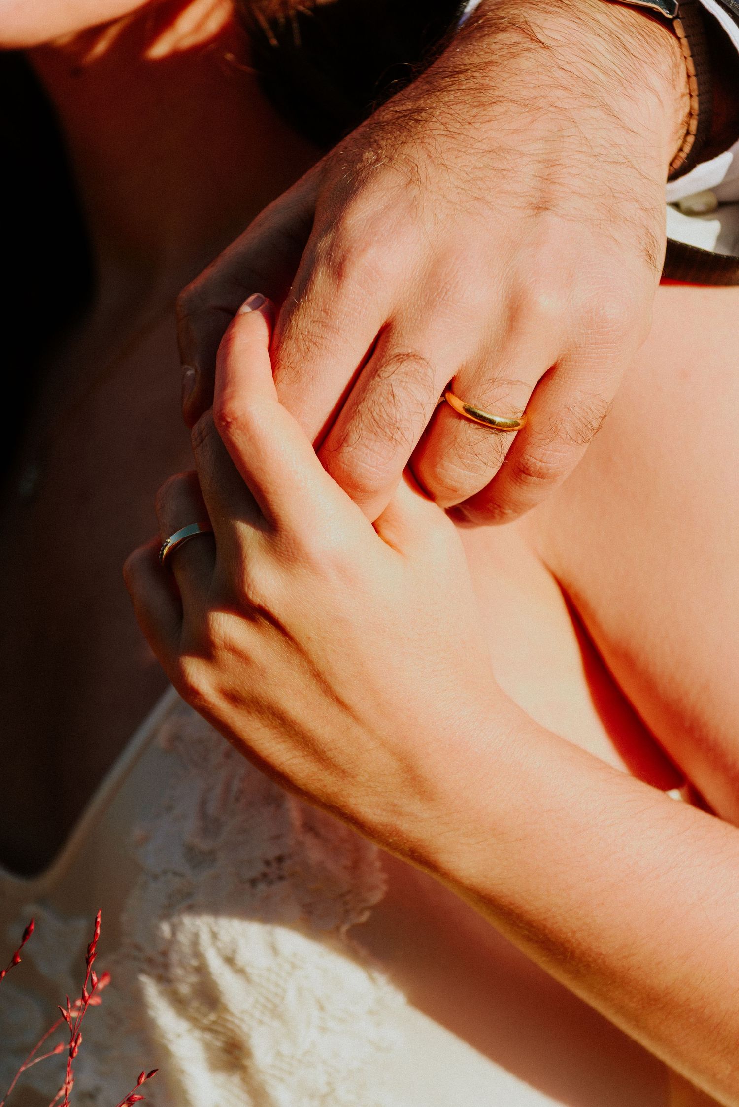 Close-up series of hands with wedding rings in natural light showing intimate wedding details.