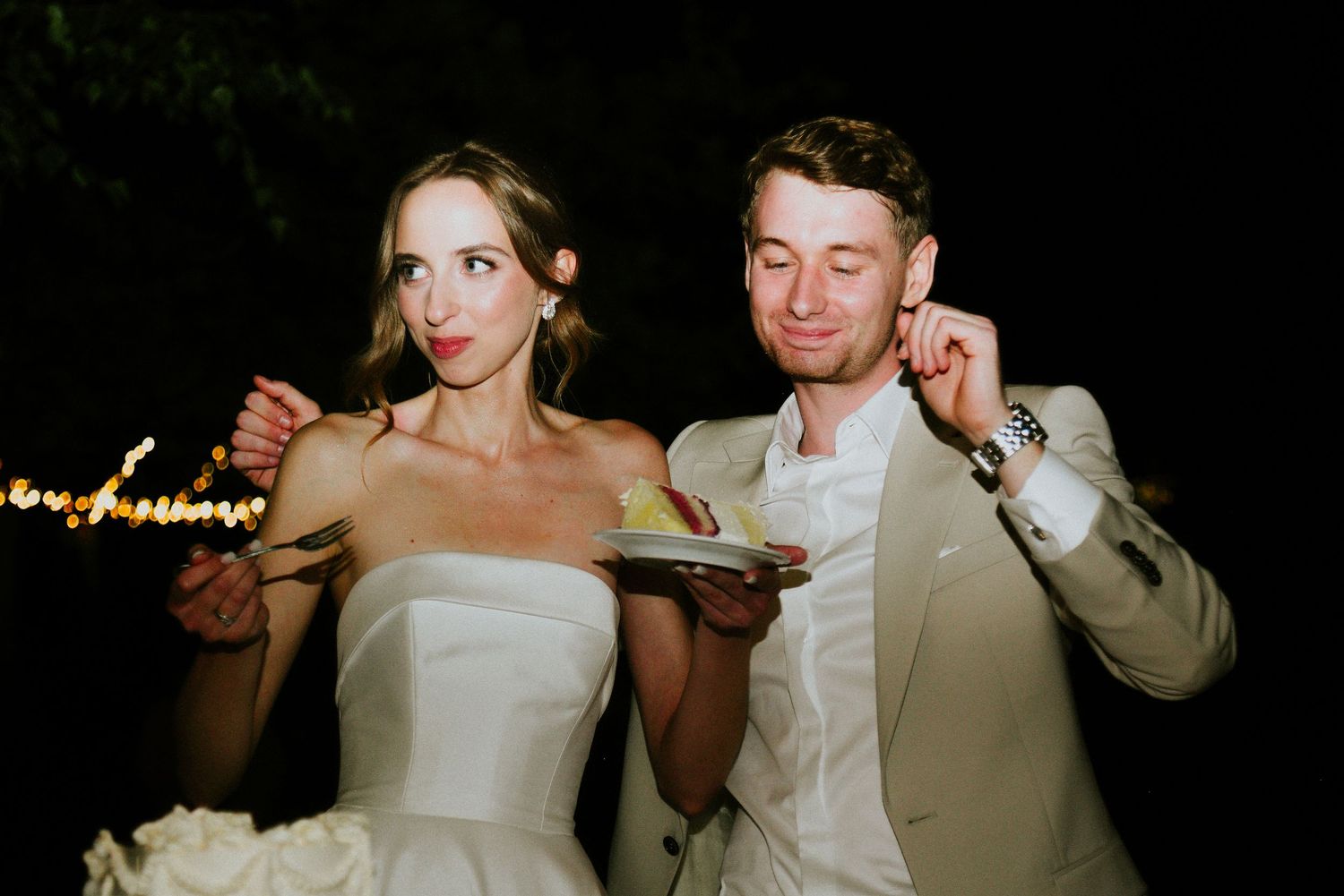 Newlyweds enjoy their first dance together at an evening wedding reception.
