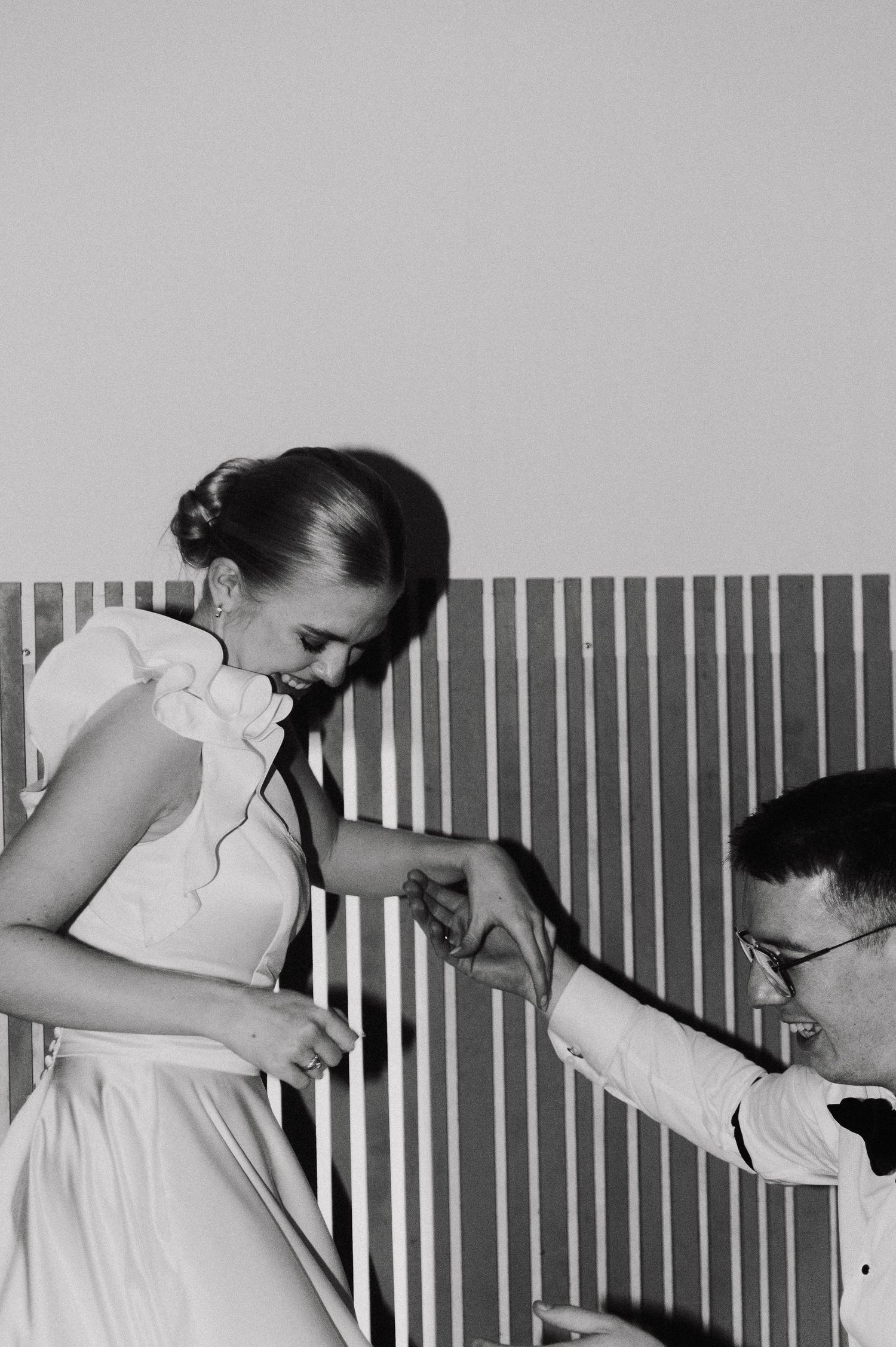 Black and white wedding photo series capturing intimate moments between a couple in formal attire.