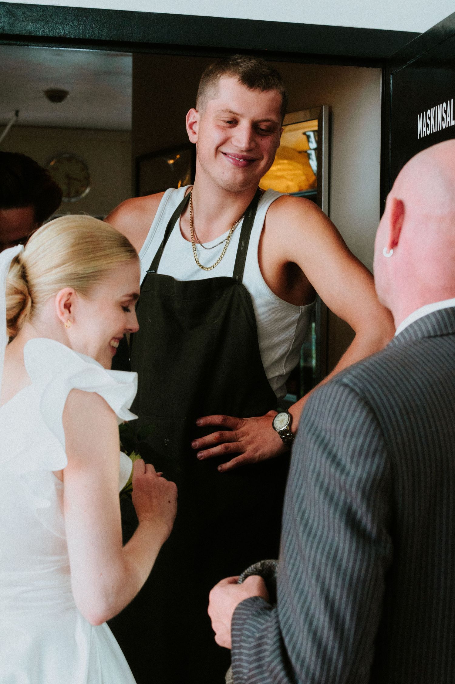 A series of candid wedding reception photos showing guests interacting in a casual indoor setting.