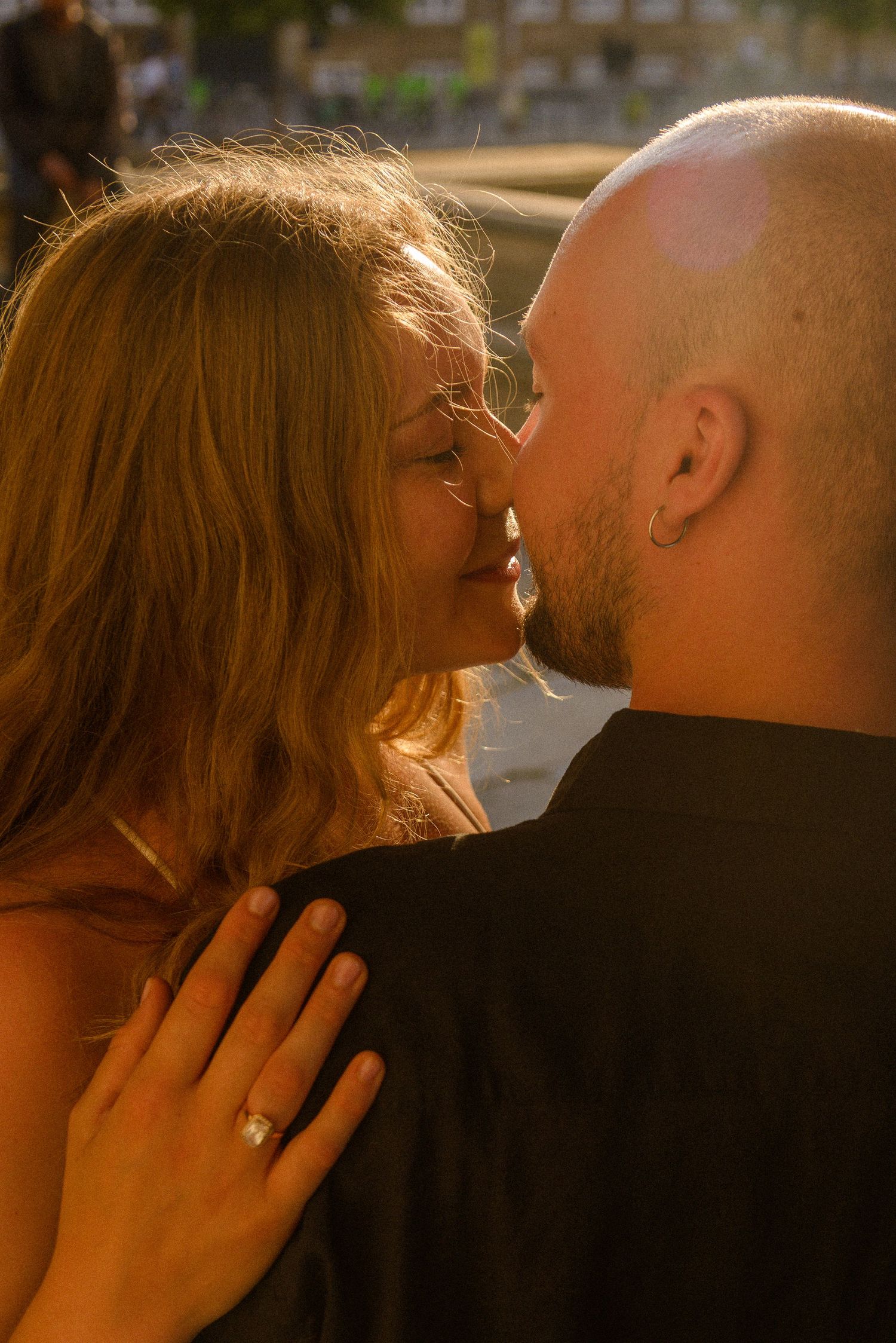 Romantic couple sharing an intimate moment in warm sunset lighting.