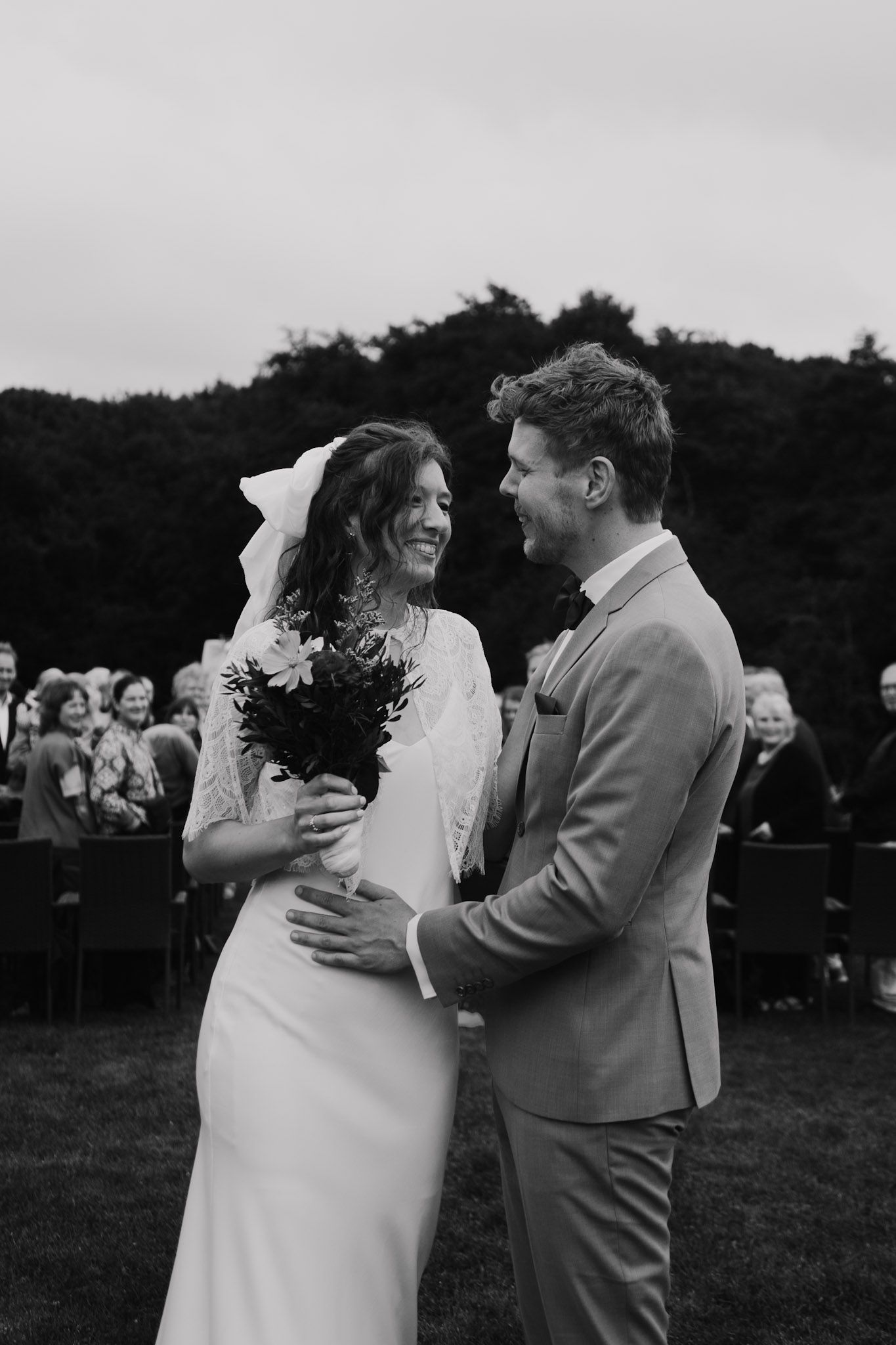 Black and white photo sequence showing a couple's first dance at their wedding reception outdoors.