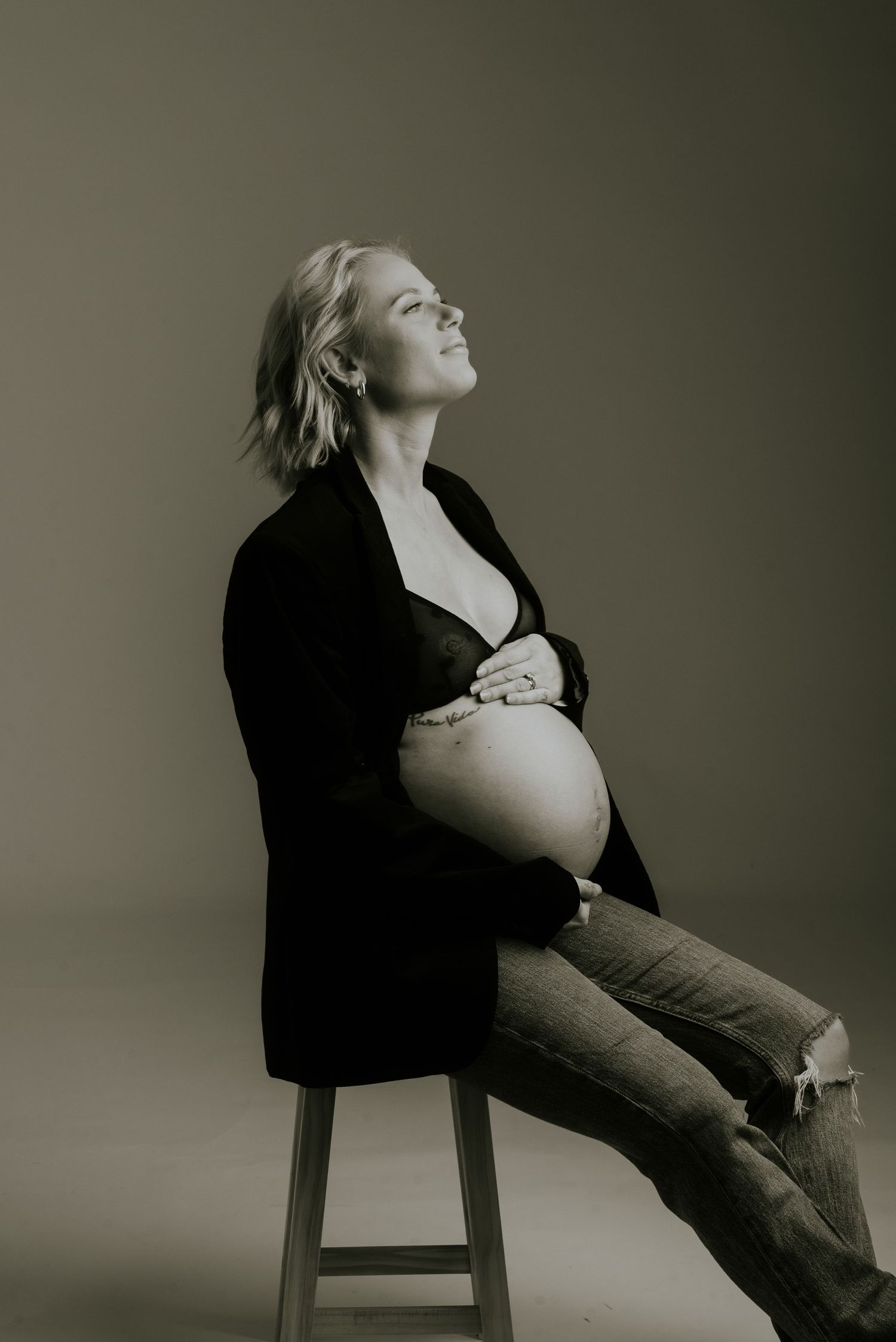 A dramatic black and white portrait series shows a person in a chair leaning back against a dark background.