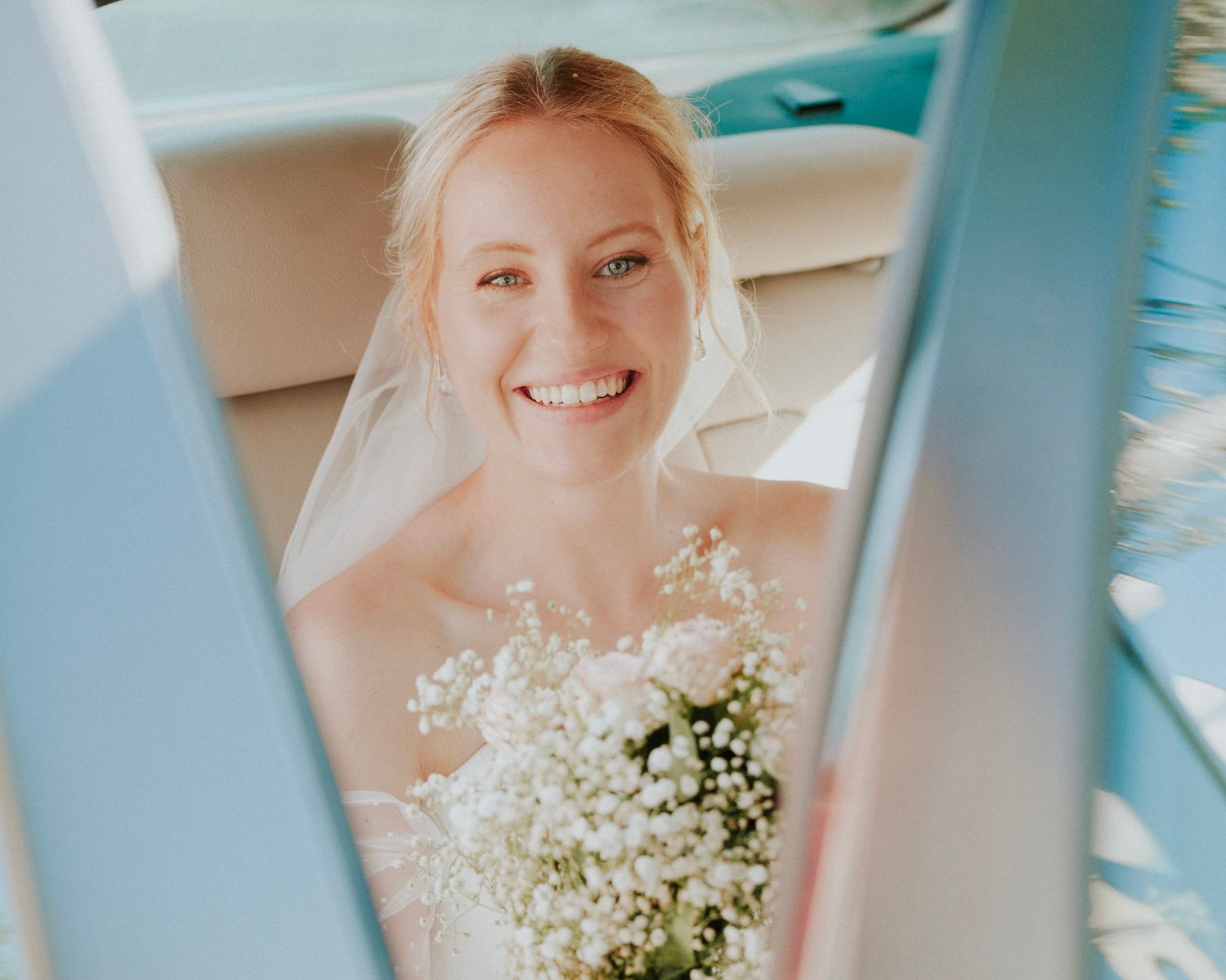 Ethereal wedding portrait through window panes with soft natural light.