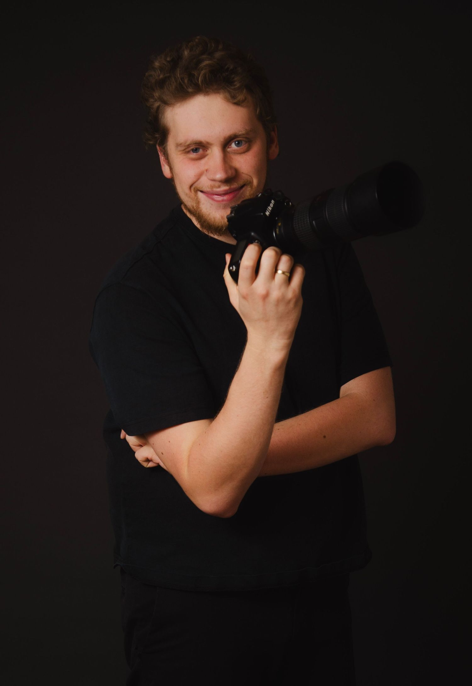 A series of black and white portraits showing someone in a dark shirt against a black background making expressive gestures.