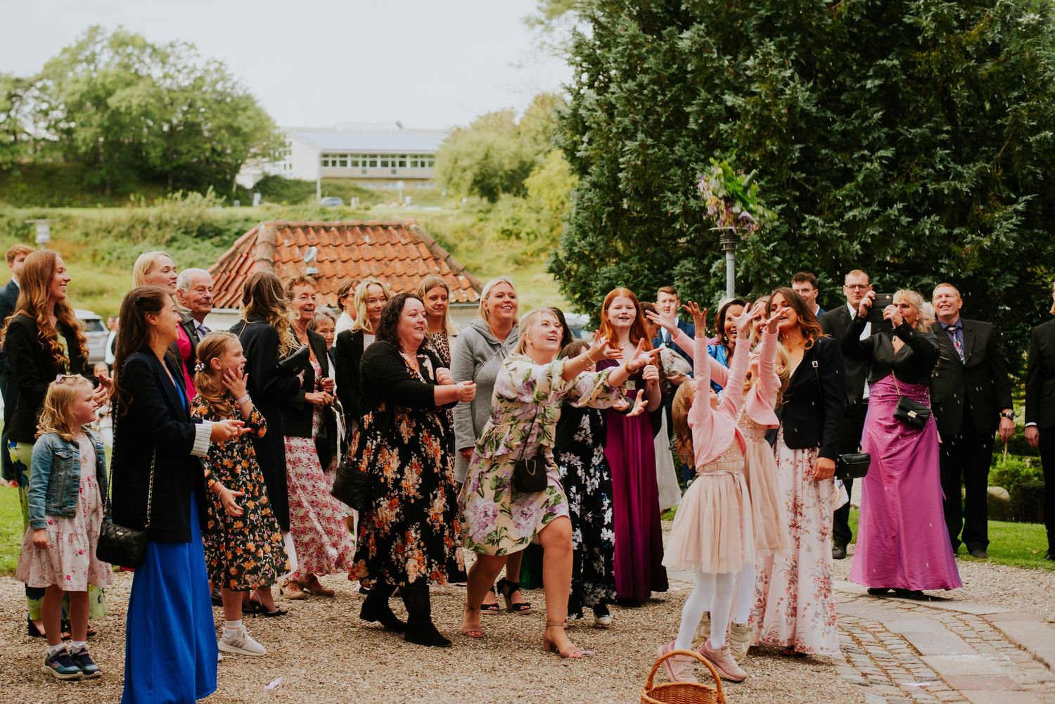 Wedding guests dance and celebrate at an outdoor reception.