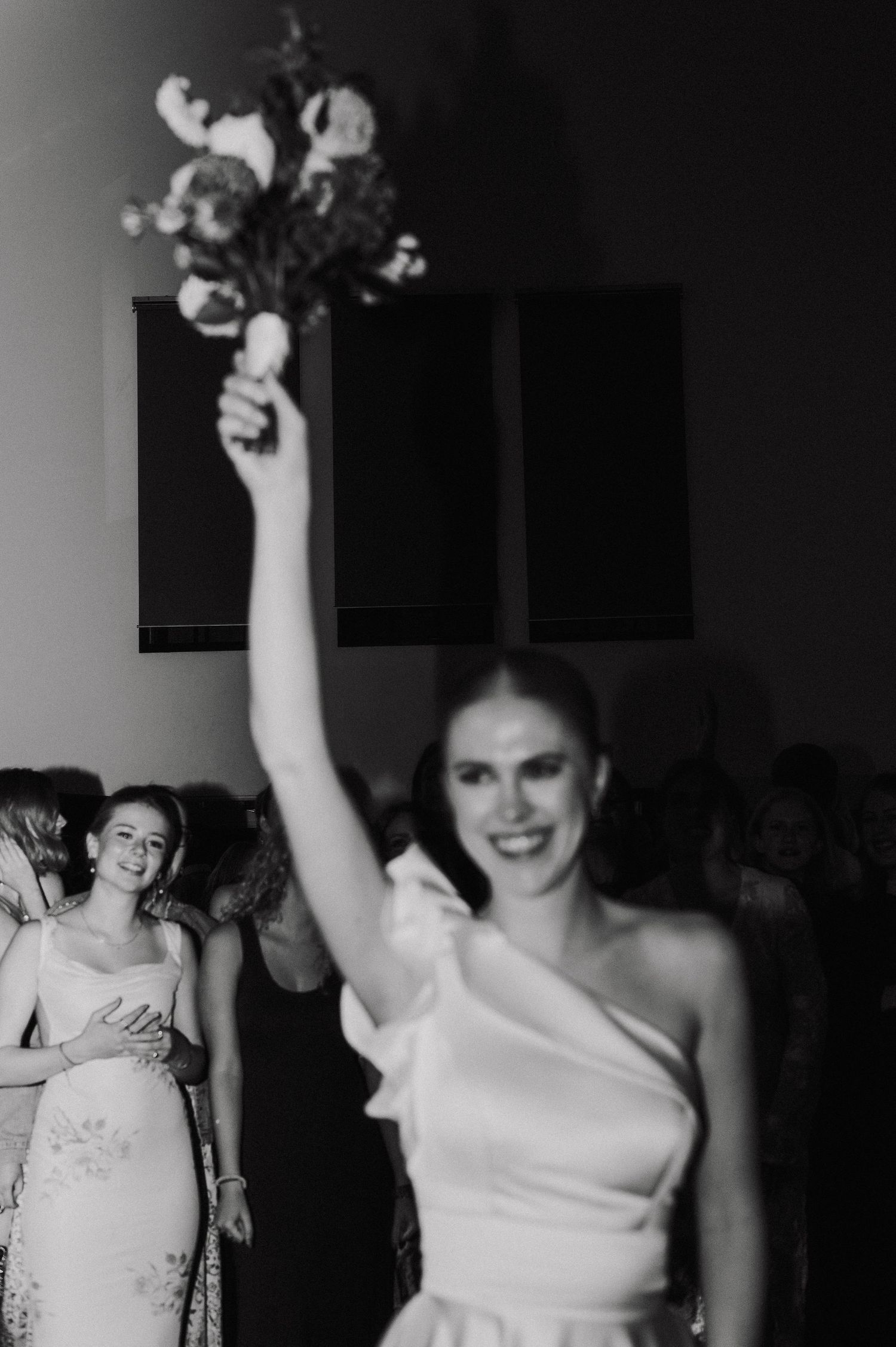 A series of black and white photos showing someone in a white wedding dress celebrating with raised arms.