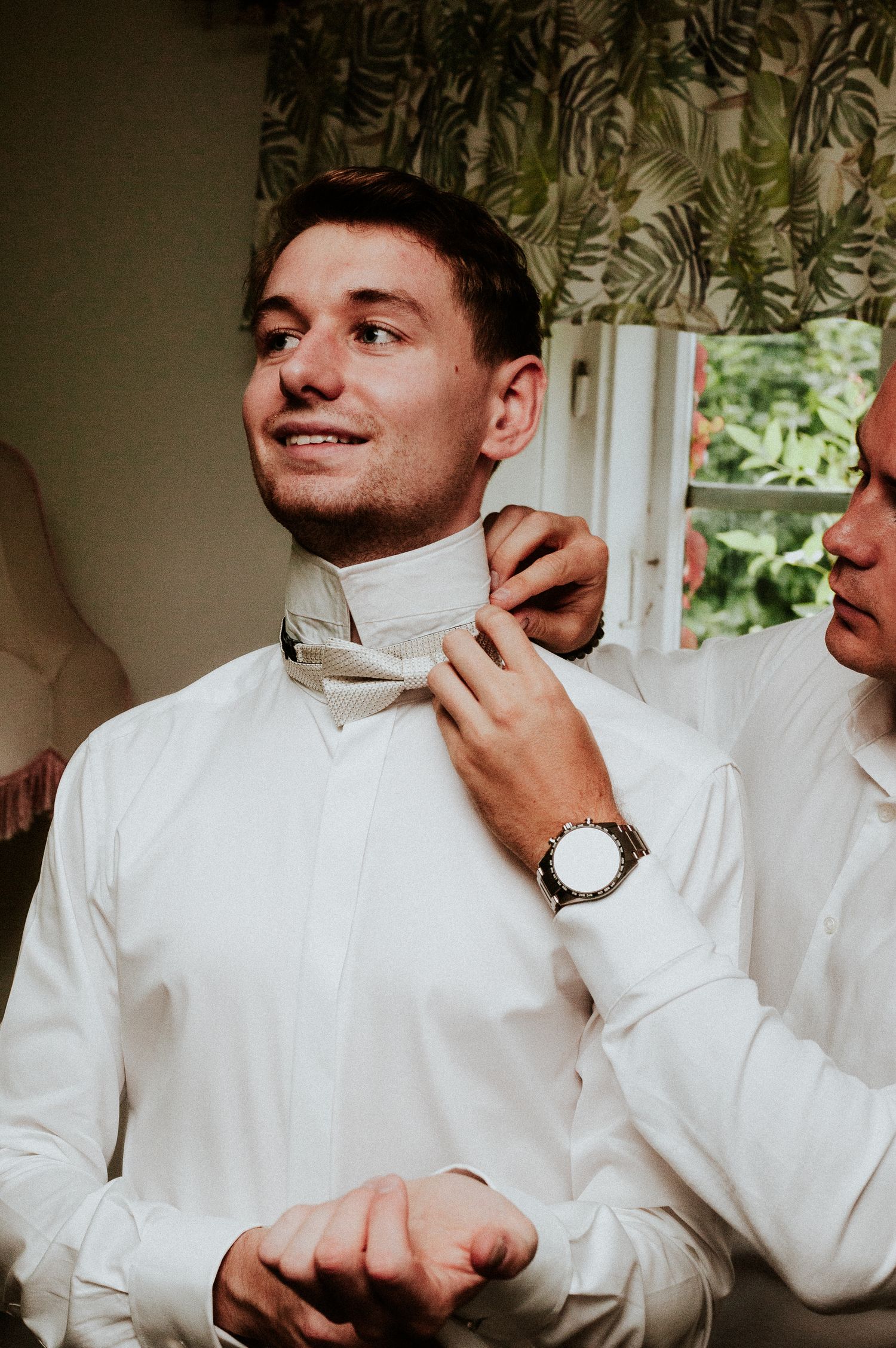 A sequence of photos showing someone adjusting a white dress shirt collar and tie while getting ready.