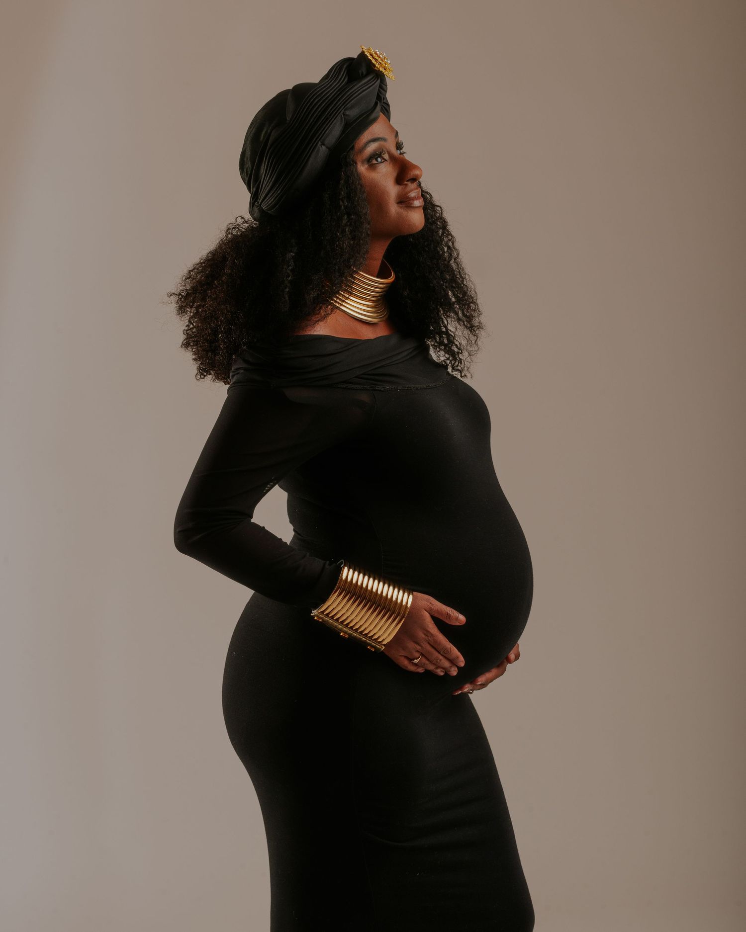 A series of artistic maternity photos showing a woman in black against a neutral backdrop in various elegant poses.