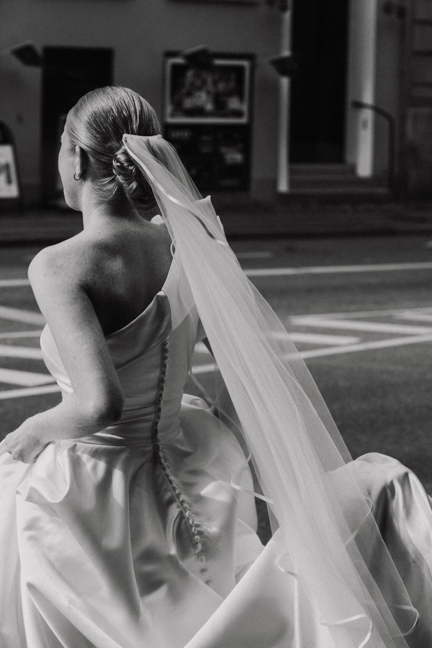 Black and white photos showing the elegant movement of a wedding dress in an indoor space.