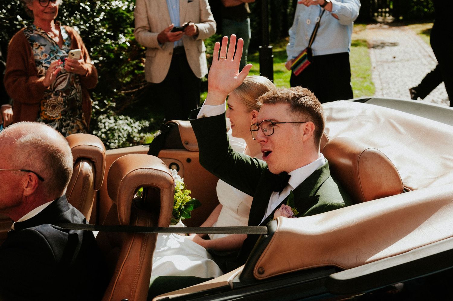 A couple shares a joyful moment together during their wedding celebration at an outdoor venue.