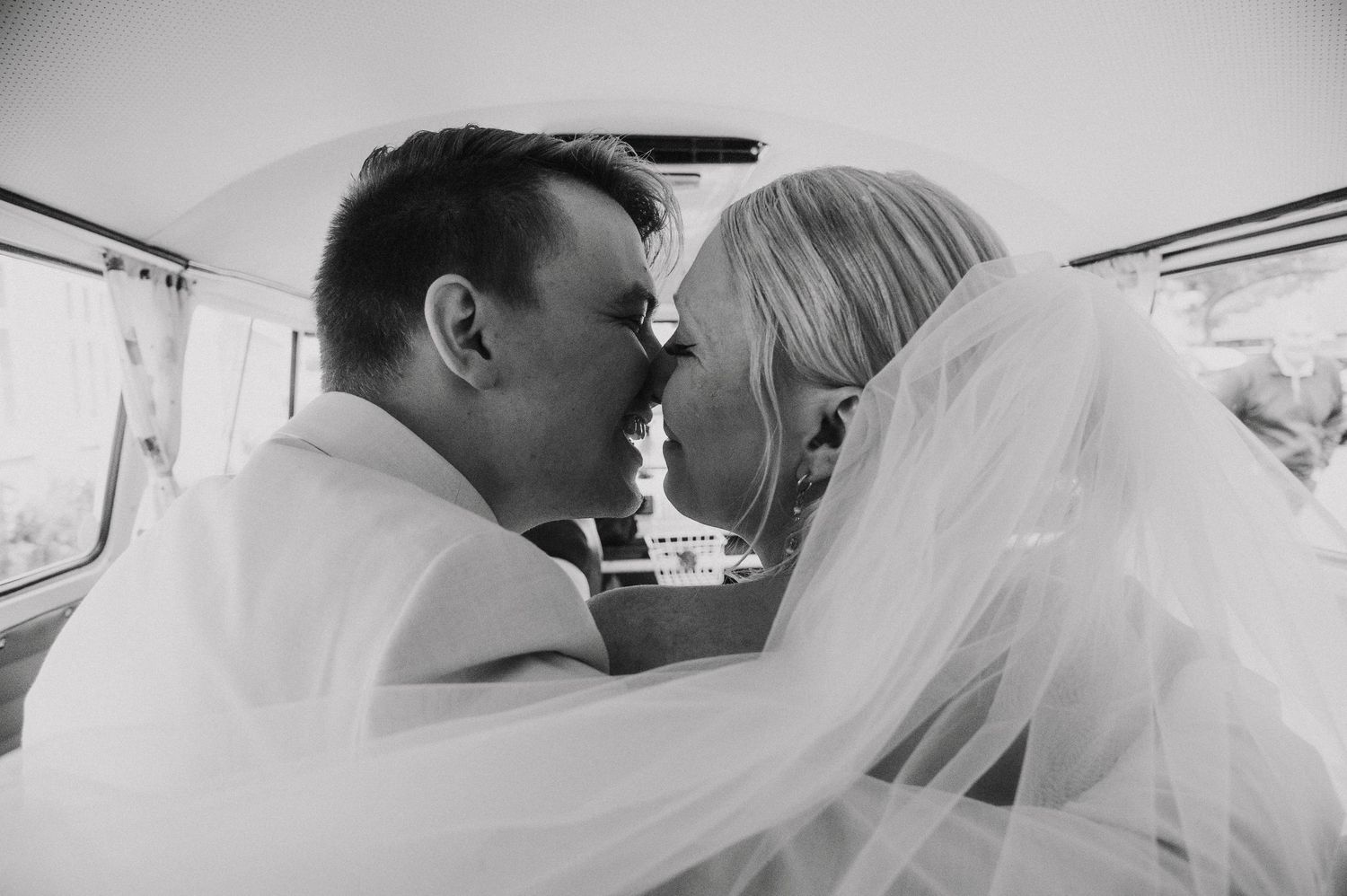 A romantic black and white photo montage of a couple kissing during their wedding day celebration.