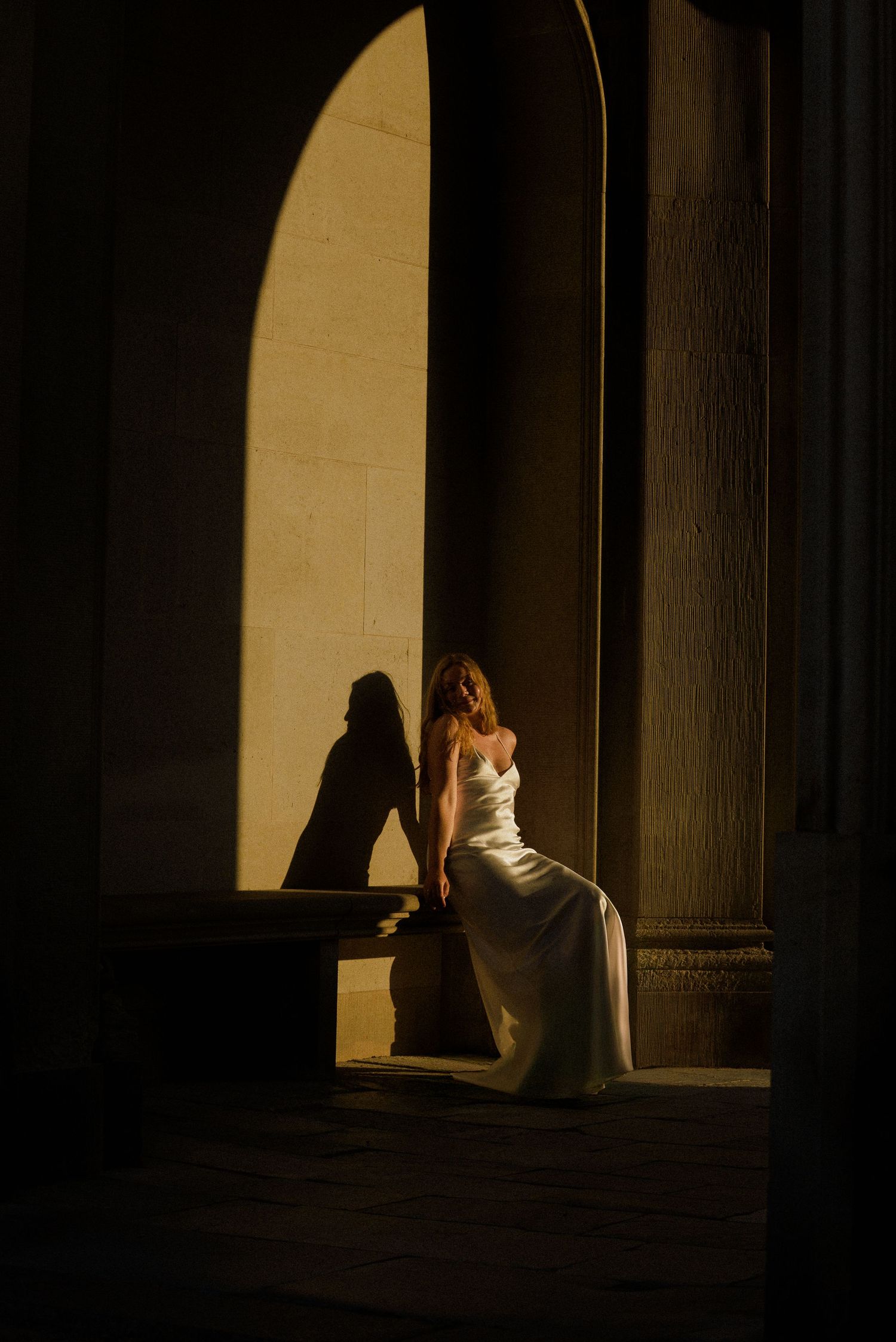 A sequence of silhouettes showing a figure sitting in dramatic lighting against a bright window or doorway.