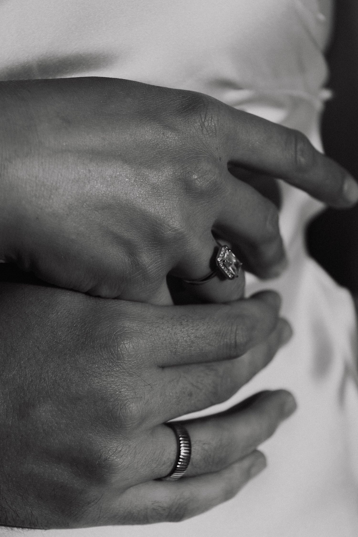 Close-up series of hands wearing wedding rings on white background showing different angles.