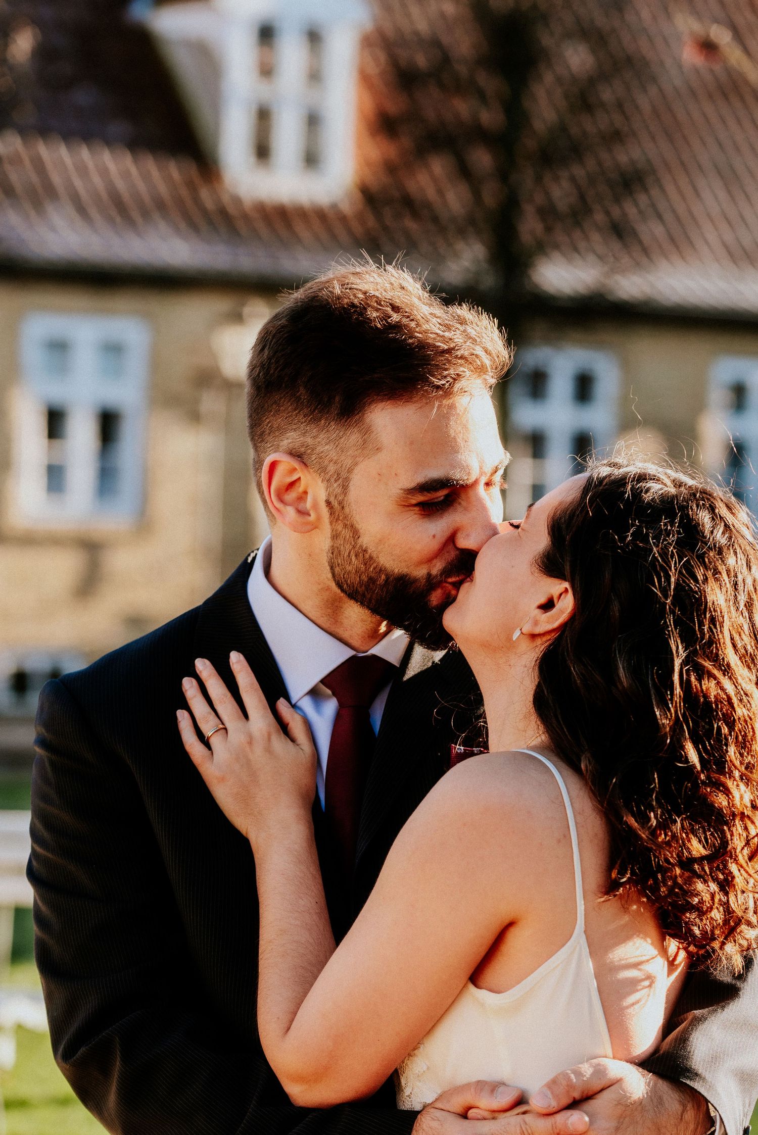 A romantic outdoor wedding photoshoot with sunlit moments between newlyweds in a rustic setting.