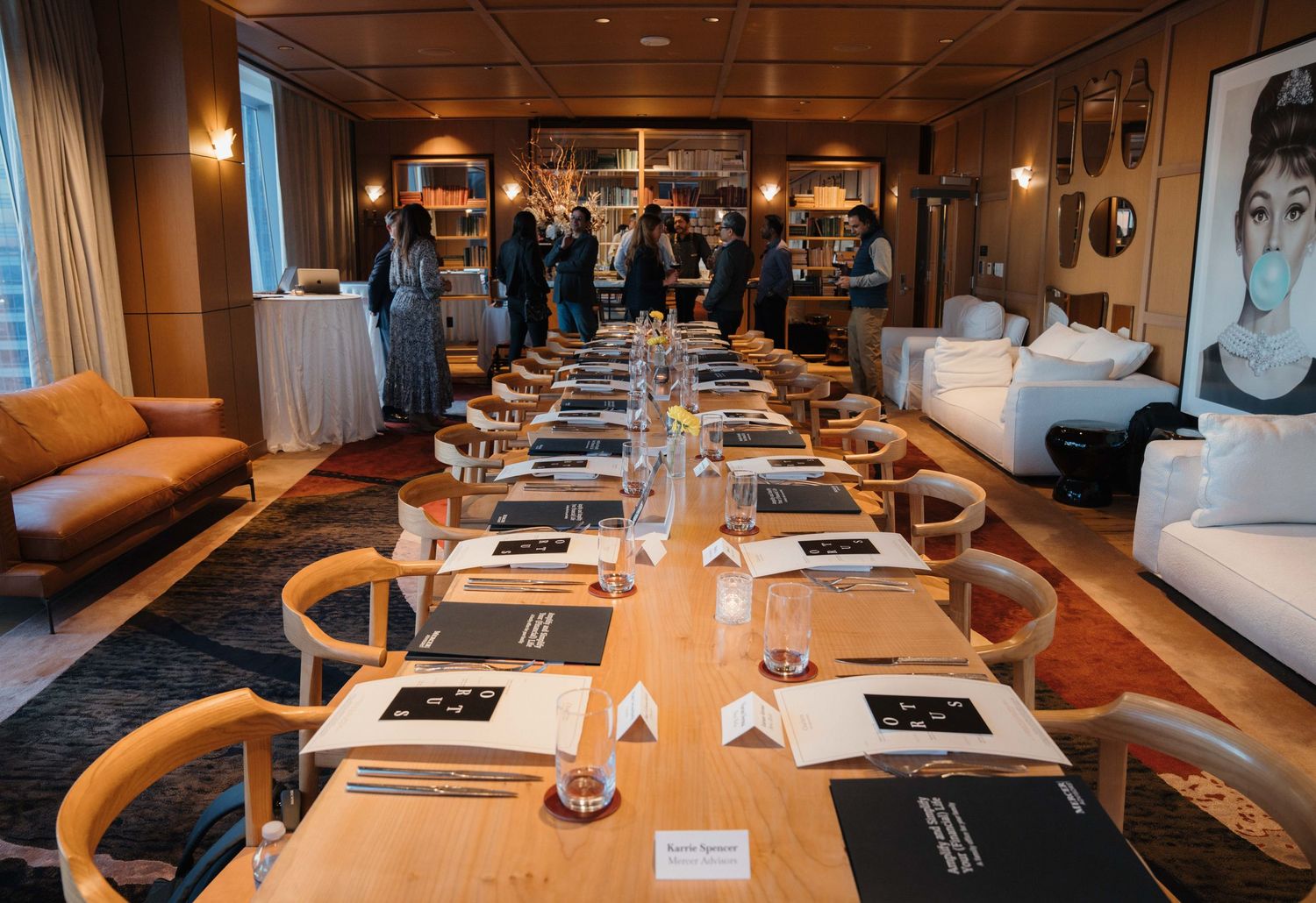 Modern cruise ship dining room interior with warm lighting, elegant place settings, and plush orange seating.