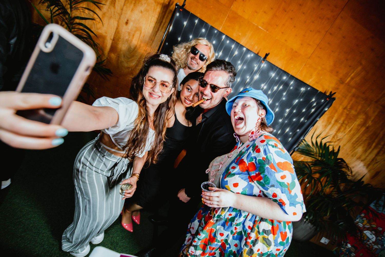 A series of candid party photos showing people dancing and celebrating at a festive indoor event with warm lighting.