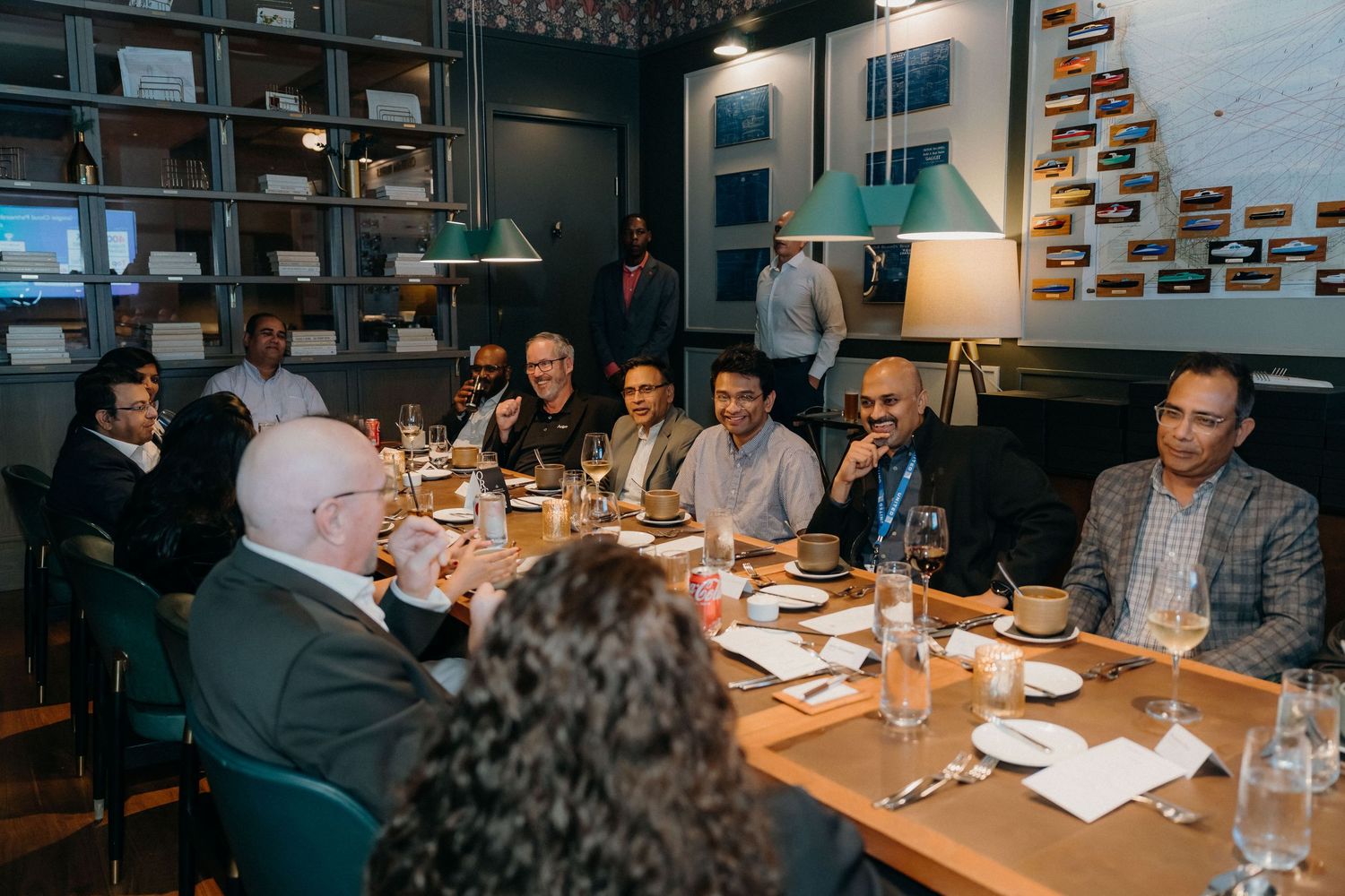 Business professionals gathered around a conference table in a modern office setting for a meeting.