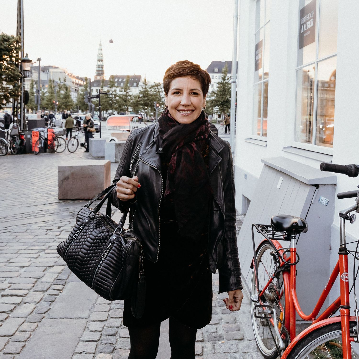 A series of street scenes with bicycles parked along cobblestone paths and building facades in an urban setting.