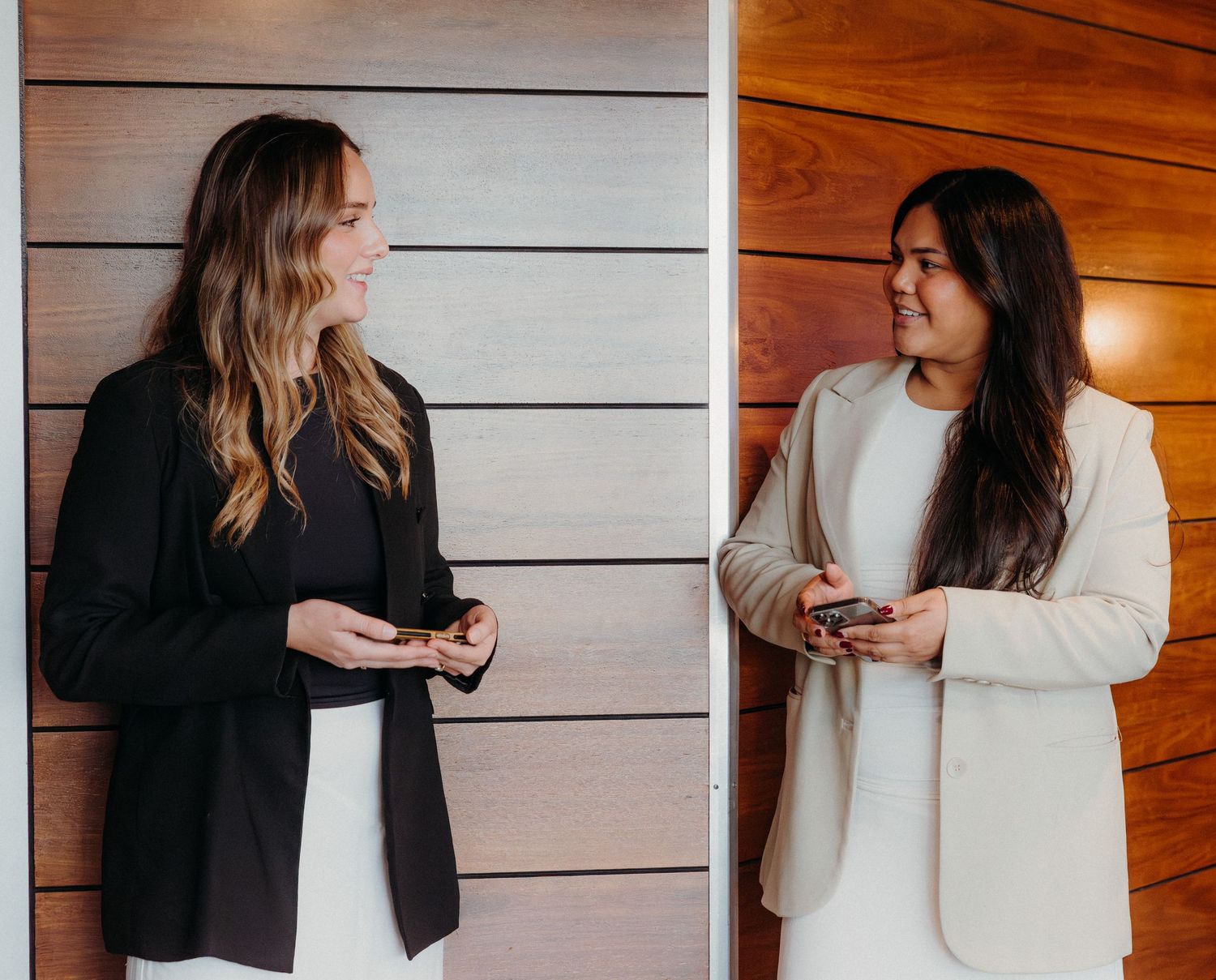 A series of photos showing two people having a conversation while standing against a wooden wall.