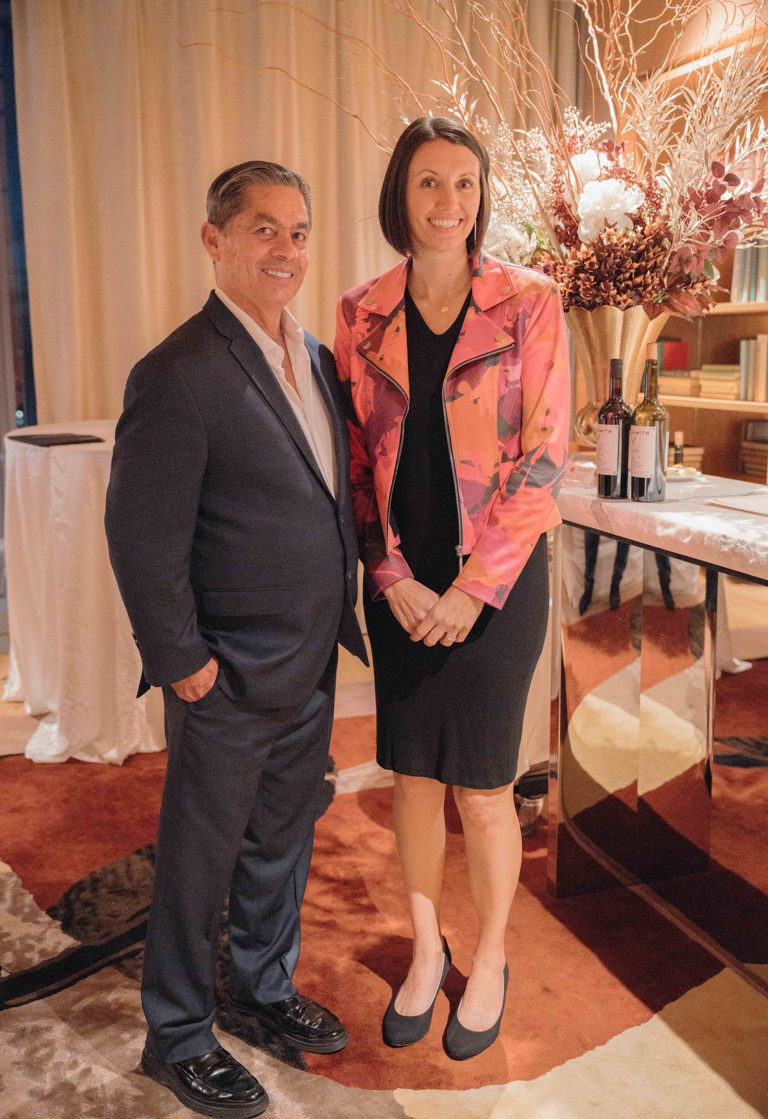 A series of candid photos showing people posing together at an elegant indoor event with white decor and pink accents.