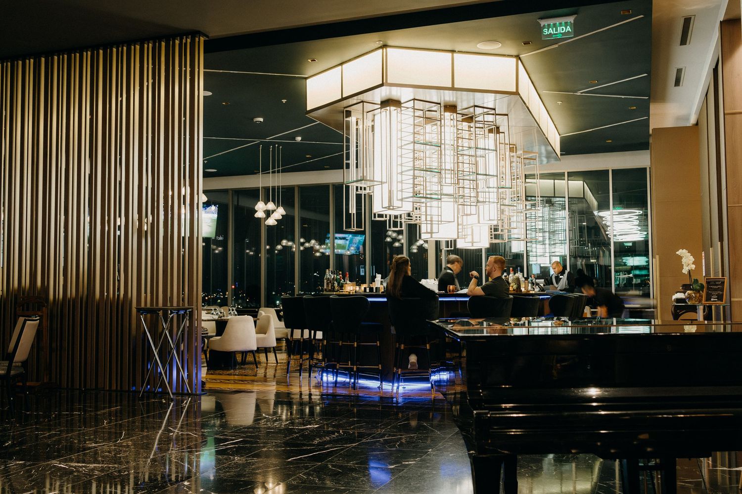 Modern restaurant interior with sleek lighting design and contemporary furnishings creates an upscale dining atmosphere.