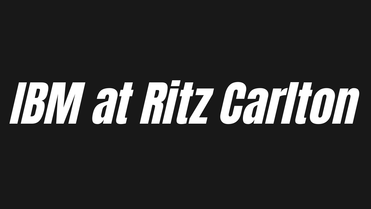 Black background with white text that reads 'IBM at Ritz Carlton' displayed on an electronic sign.