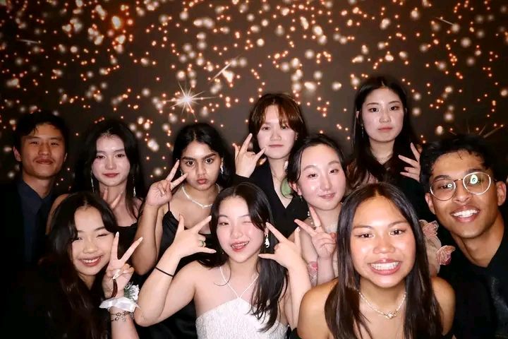 A collage of group photos showing people smiling and posing together at a festive event with glittering lights in the background.