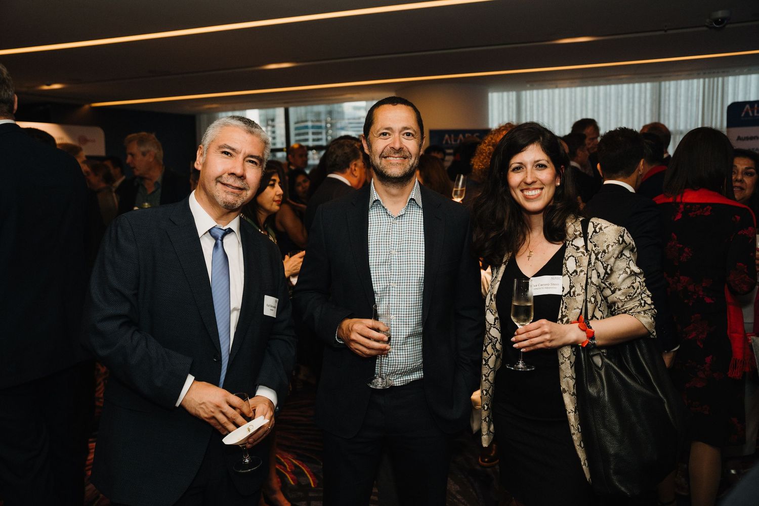 People mingling and networking at an indoor business or professional event.