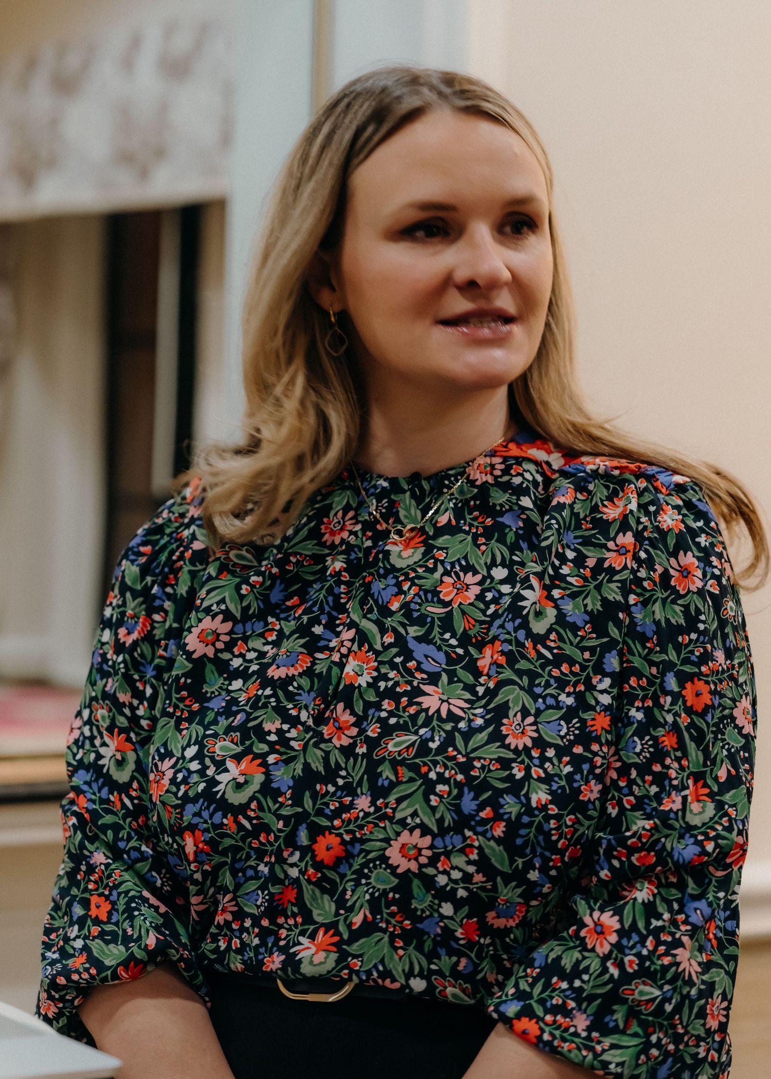 A floral print dress with puff sleeves and black background is shown from different angles in a photo collage.