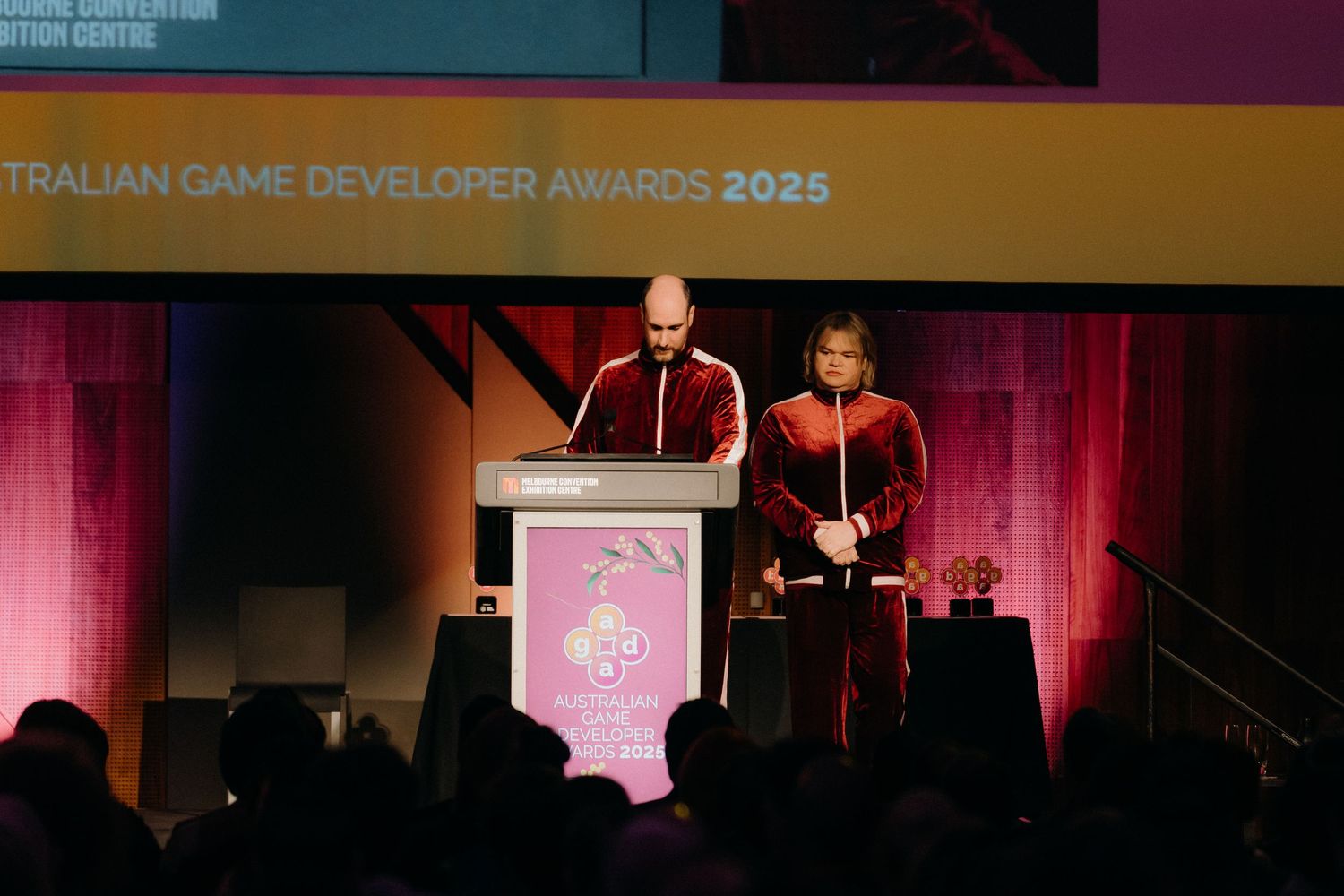 Awards ceremony stage with 'Australian Game Developer Awards 2025' text displayed on screen.