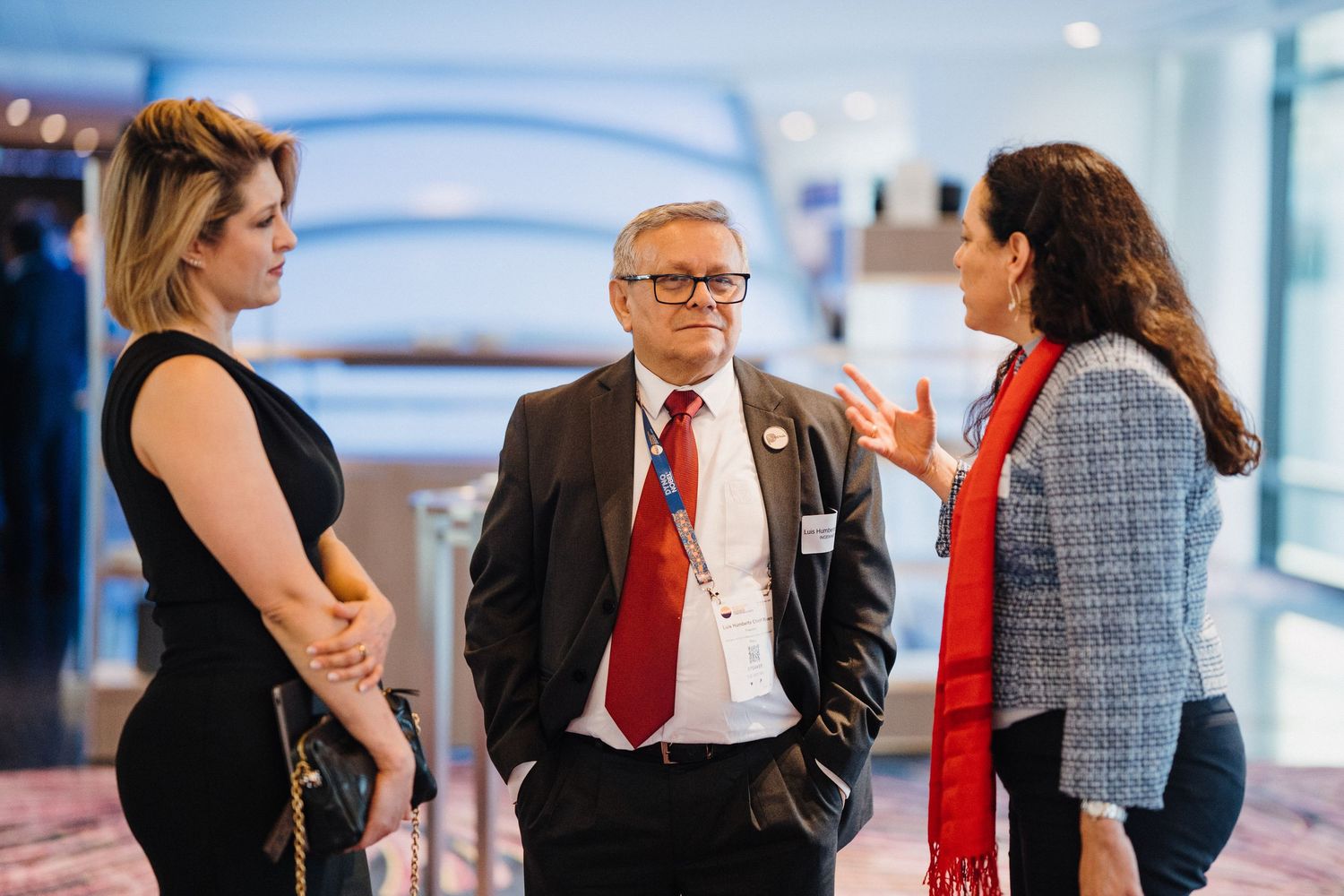 Business professionals engaged in conversation during a networking event in a modern office setting.