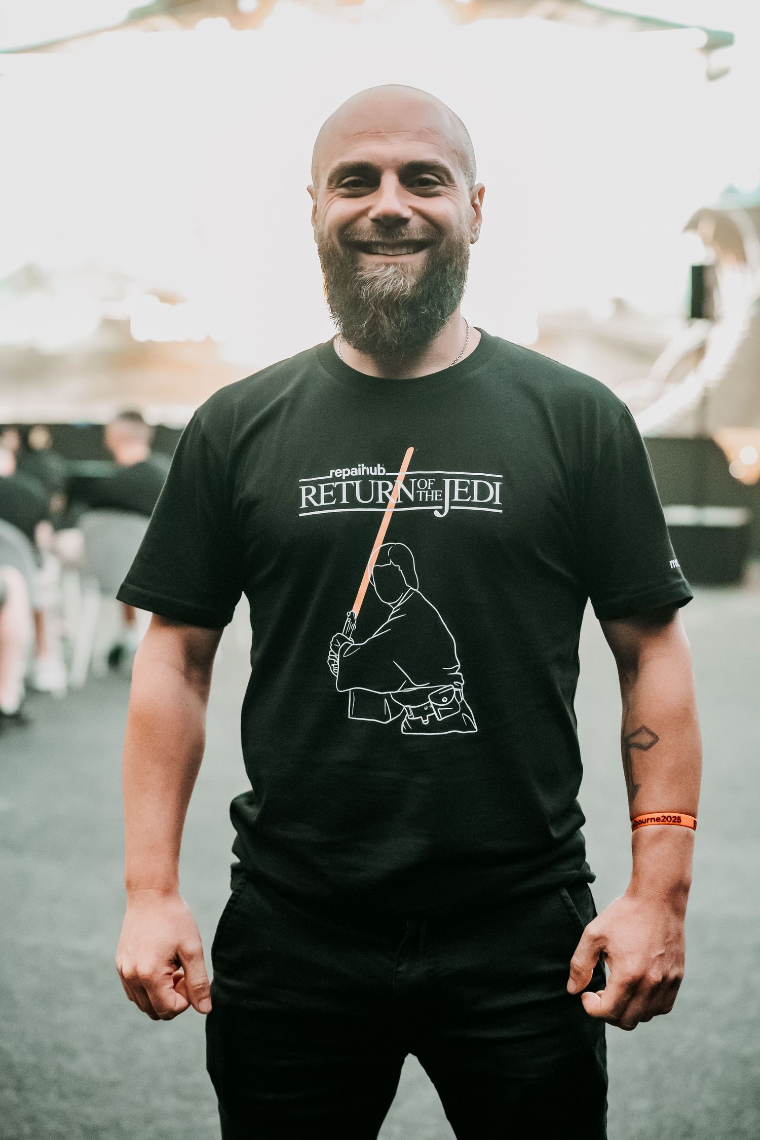 A series of photos showing someone wearing a black t-shirt with a minimalist dinosaur design on the front.