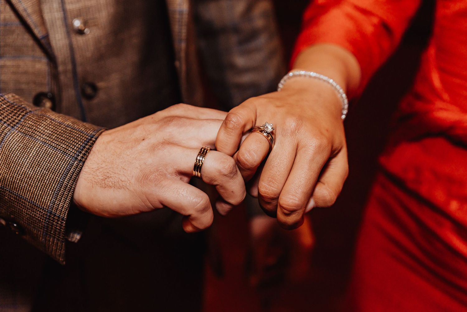 Close-up sequence showing hands exchanging wedding rings during ceremony.
