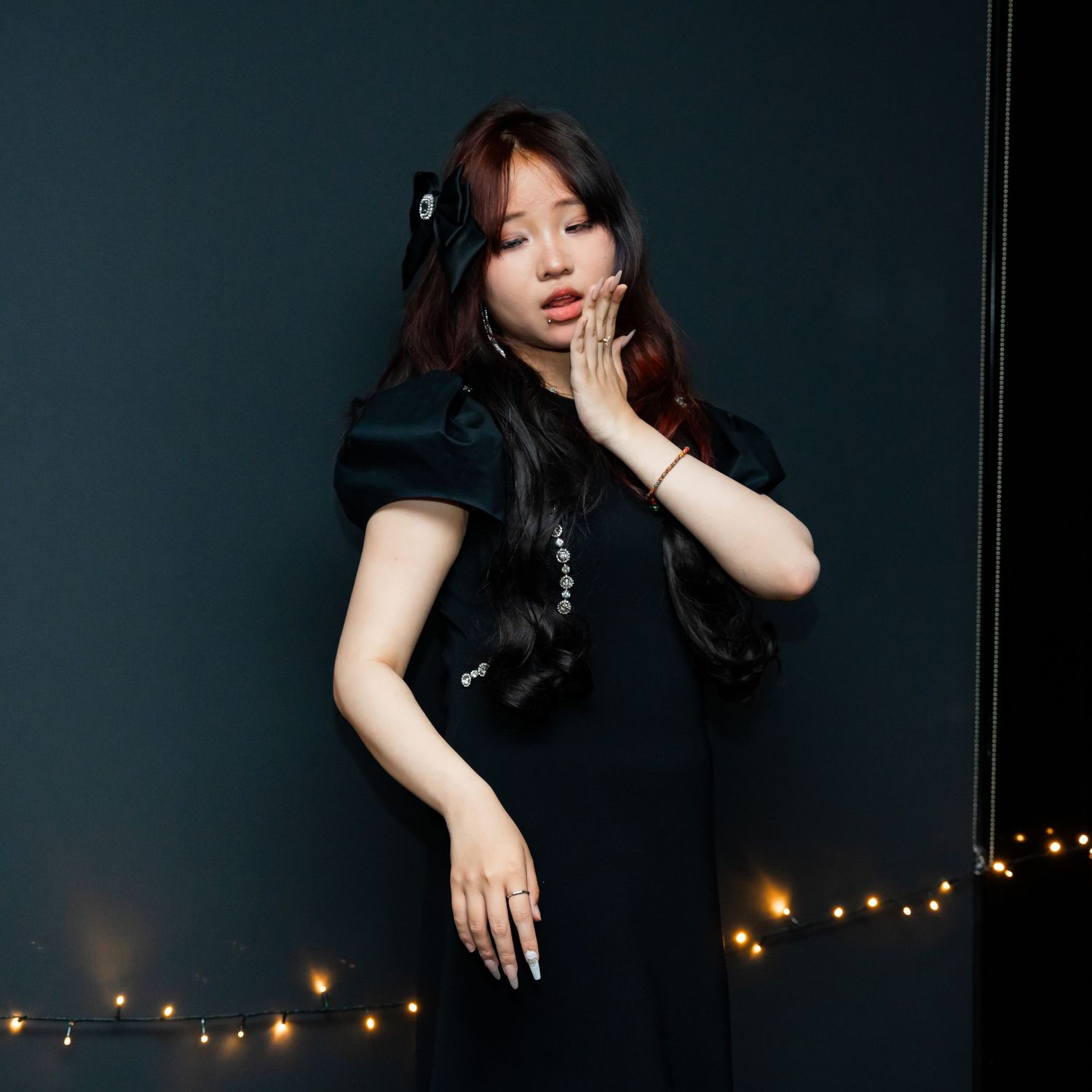 Artistic photo sequence against dark background with dramatic lighting and glowing lights in the distance.