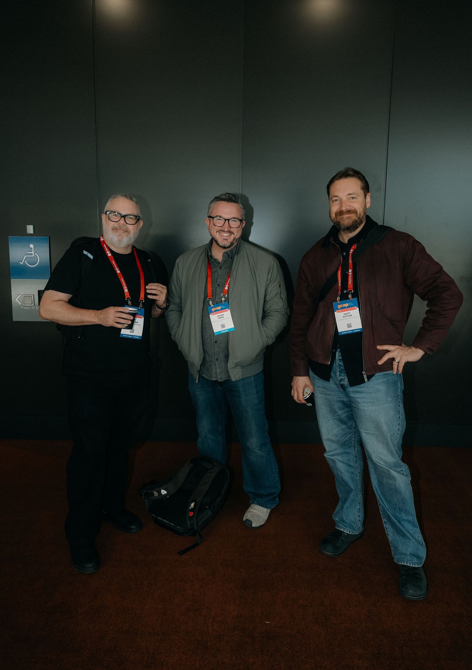 A sequence of five dark photos showing people standing together at what appears to be a conference or event.
