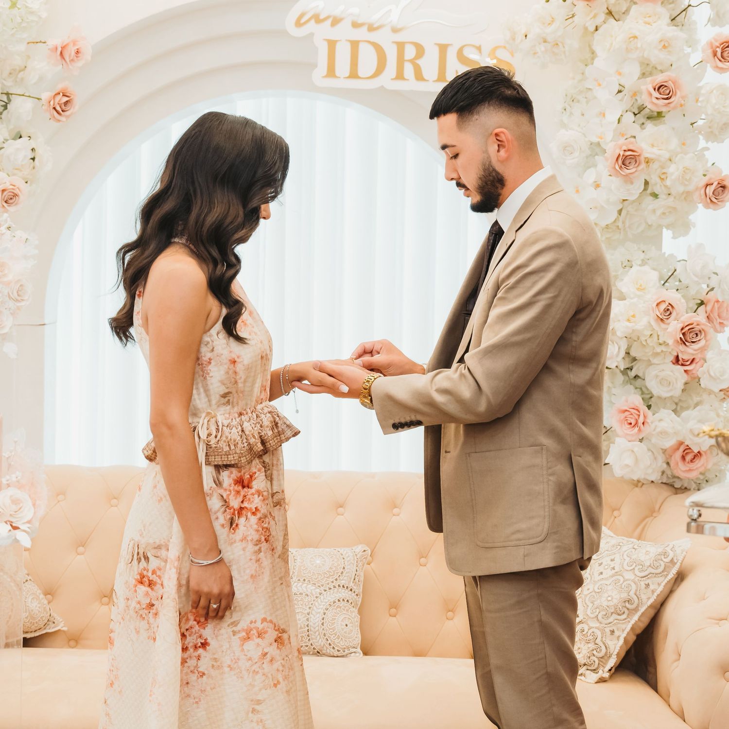 A romantic first look sequence shows a couple sharing sweet moments in a soft-lit room with floral wallpaper.