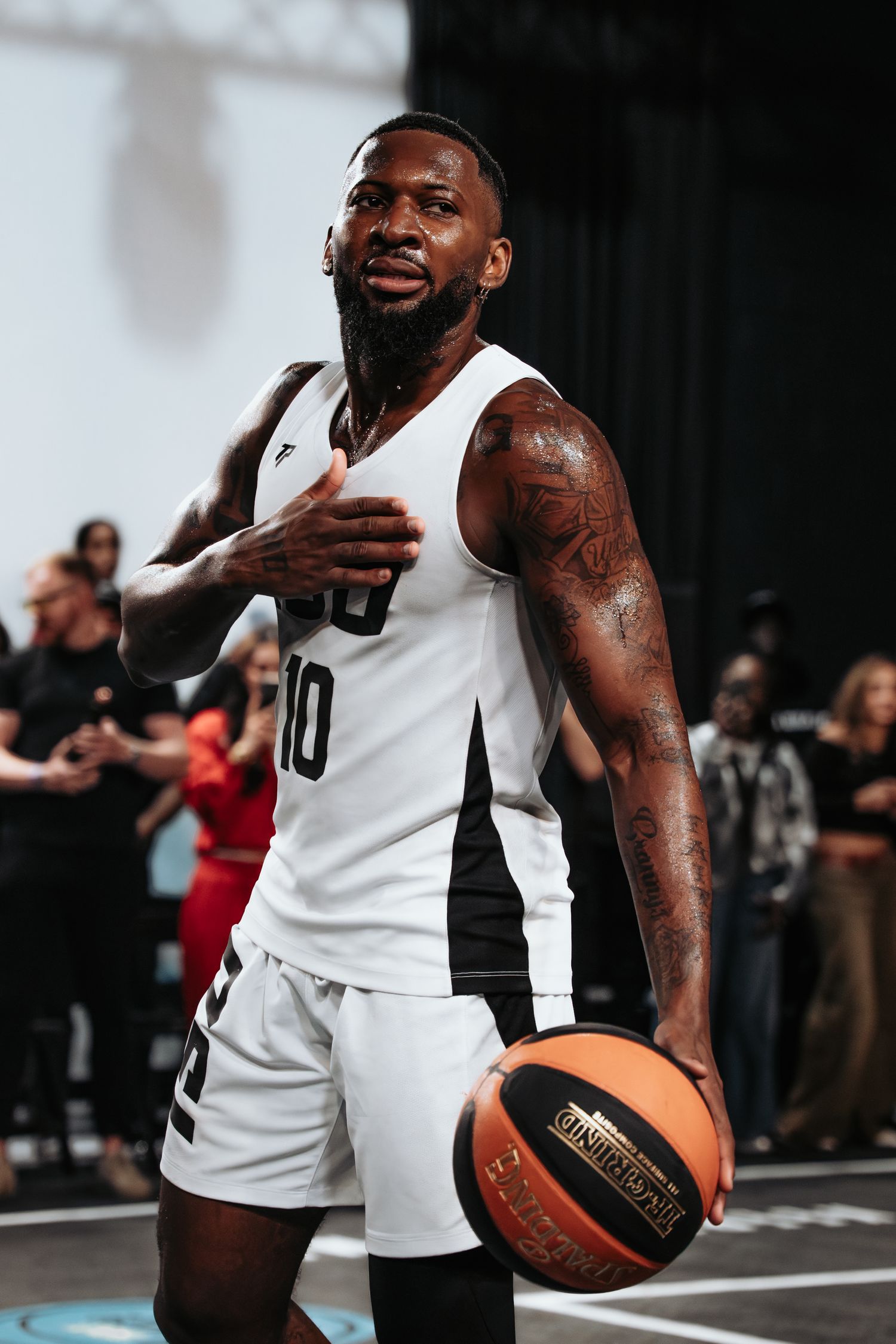 Basketball player in white jersey holding a basketball during a game or practice session.