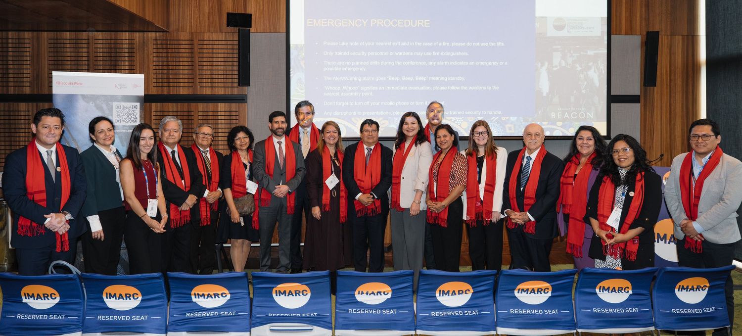 A series of five connected photos showing people in red jackets gathered at professional events and meetings.