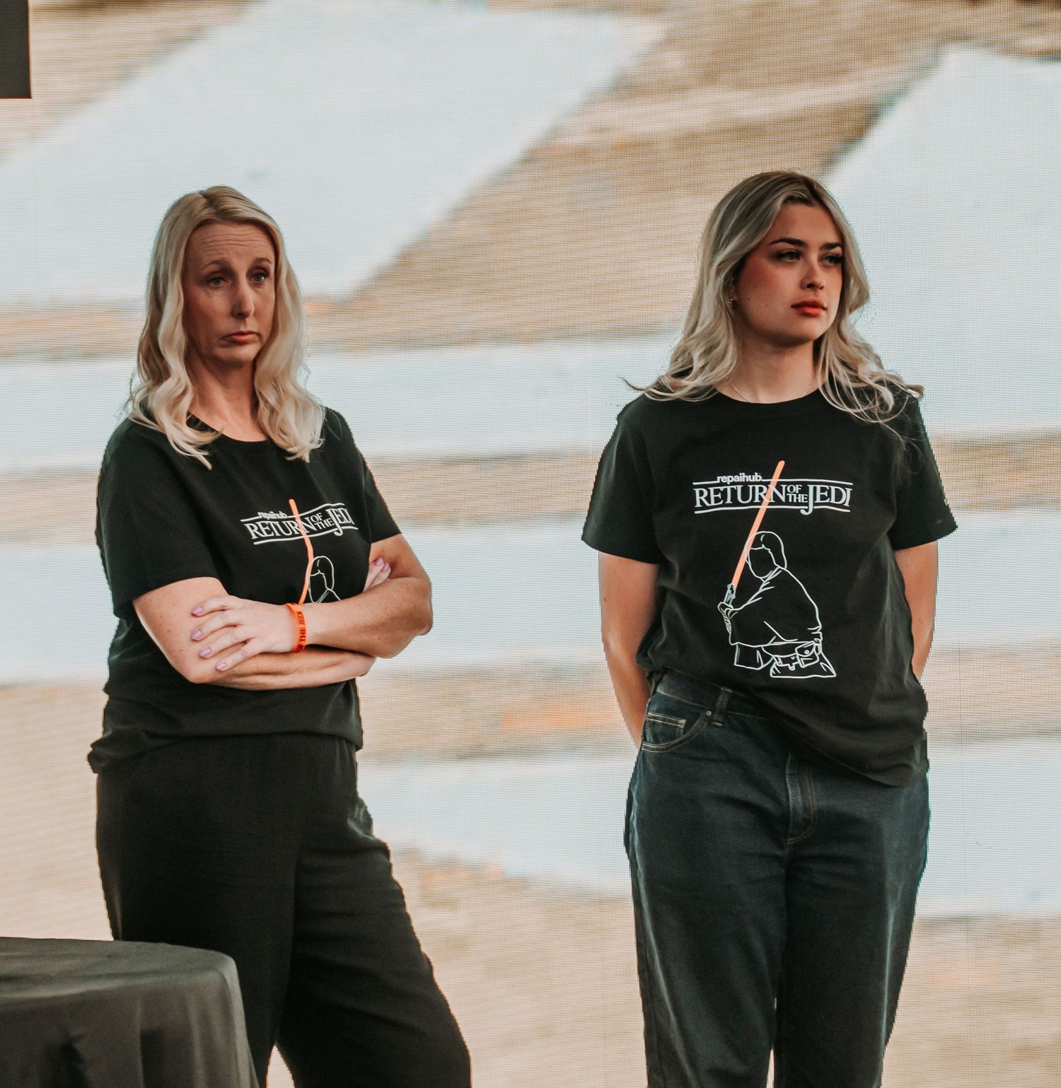 Woman in black t-shirt with graphic design shown in multiple poses against neutral background.