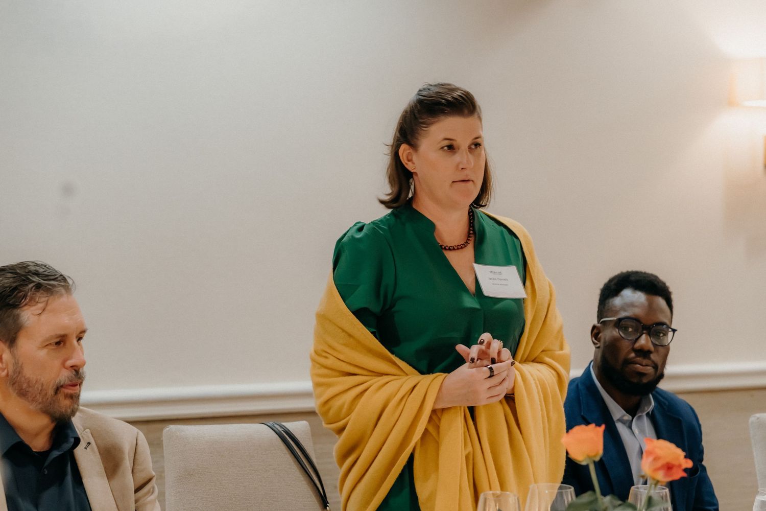 Diverse group of people engaged in conversation during a professional networking event.