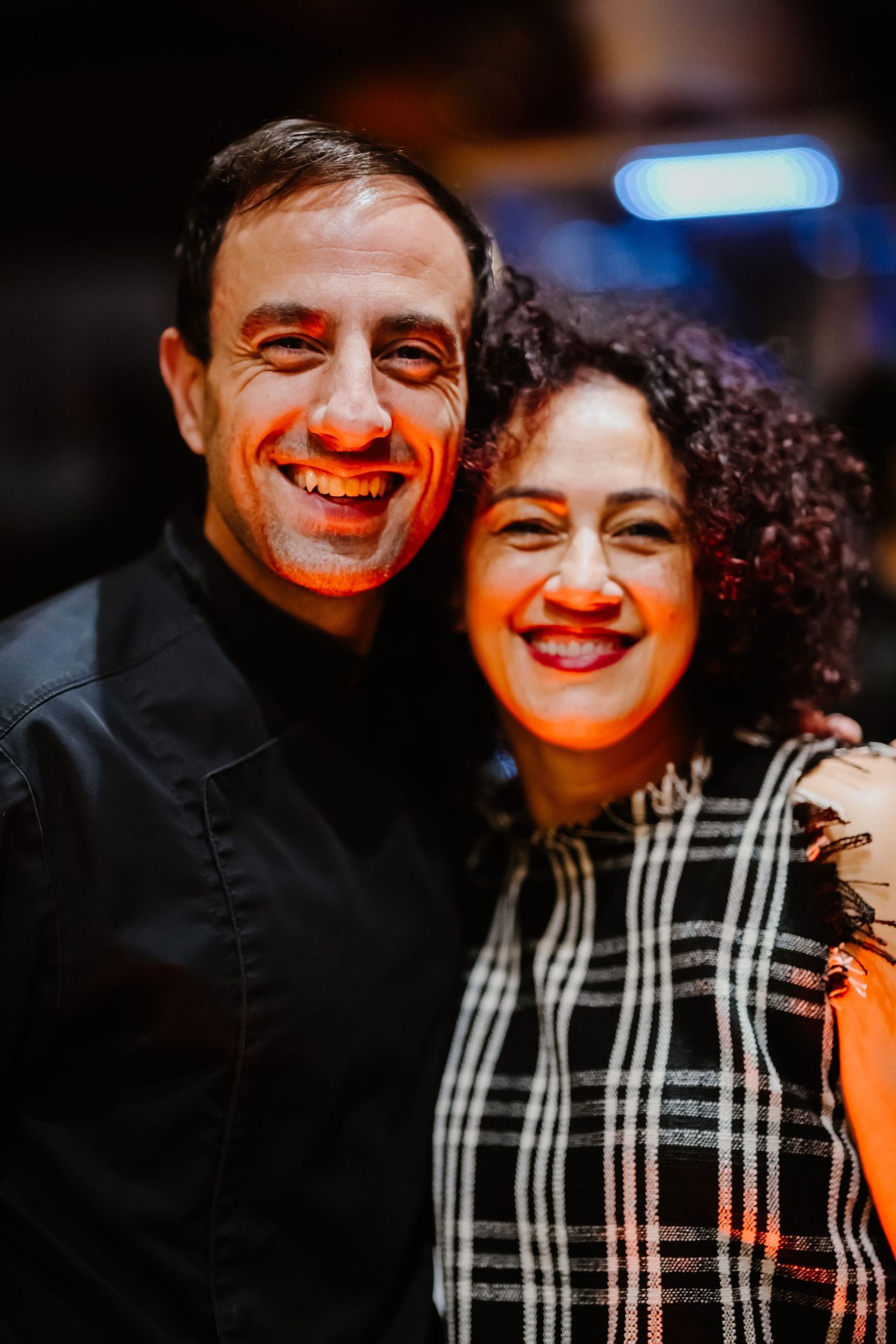 A couple shares a joyful moment together in a series of candid photos with warm lighting.