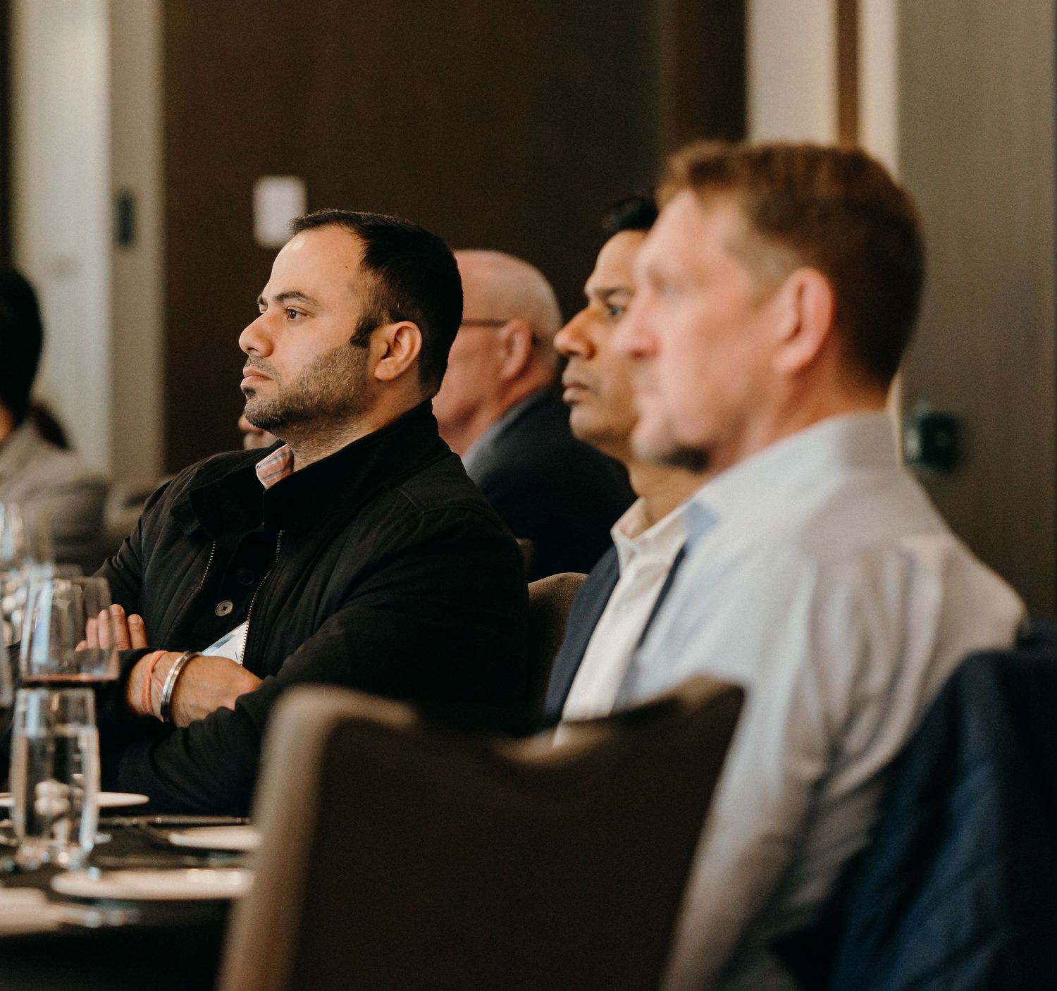 Business professionals engaged in discussion during a corporate meeting in a modern conference room.