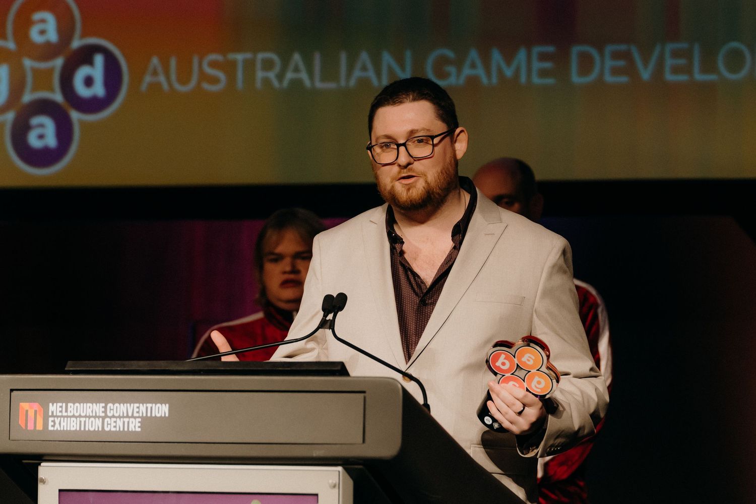A collection of six small photos showing speakers and presenters at a gaming industry conference or event.