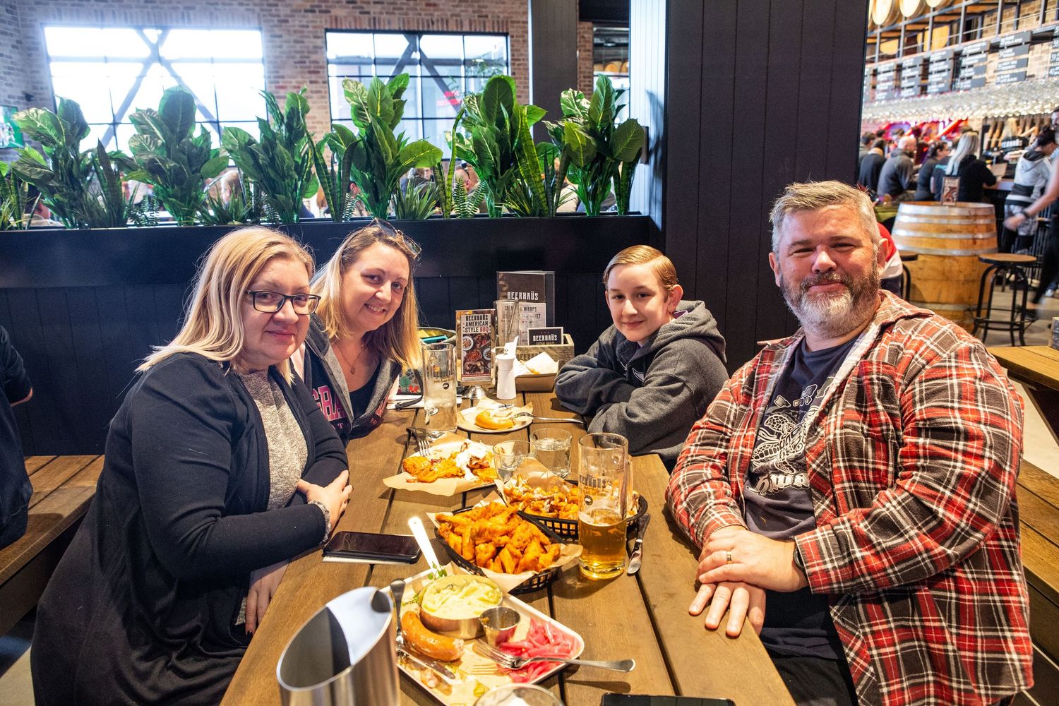 A group of people gather around a table at a restaurant for a casual dining experience.