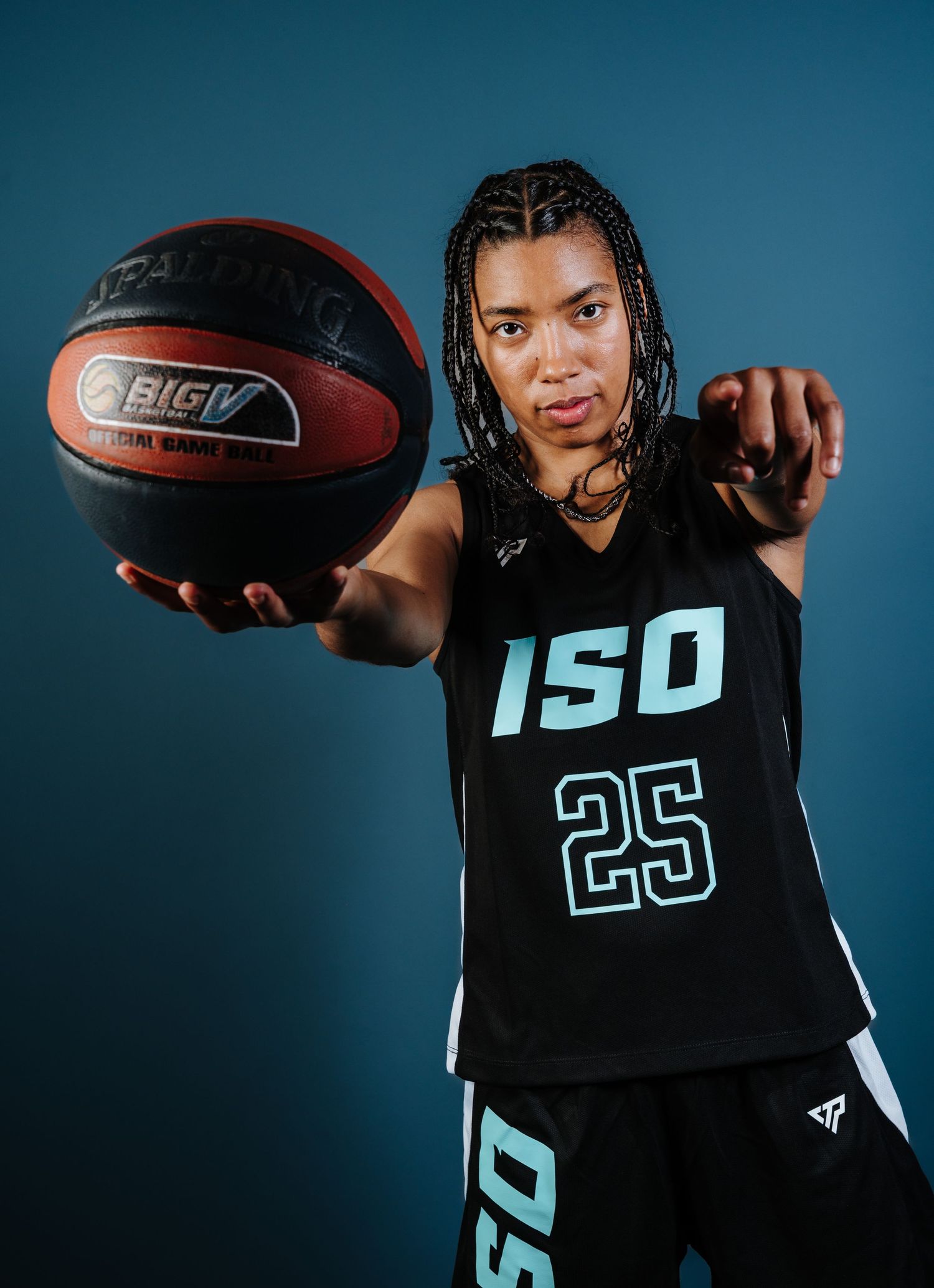 Basketball player in black jersey number 25 poses with a ball in dynamic split-screen sequence.