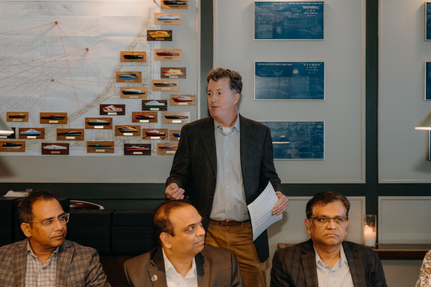 Business professionals gathered around a conference table during a meeting in a modern office space.