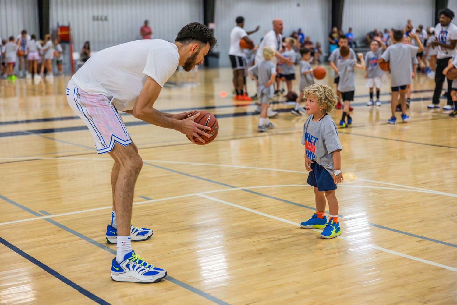 Chet Holmgren challenges a 6-year-old camper at his ProCamp in Oklahoma City.