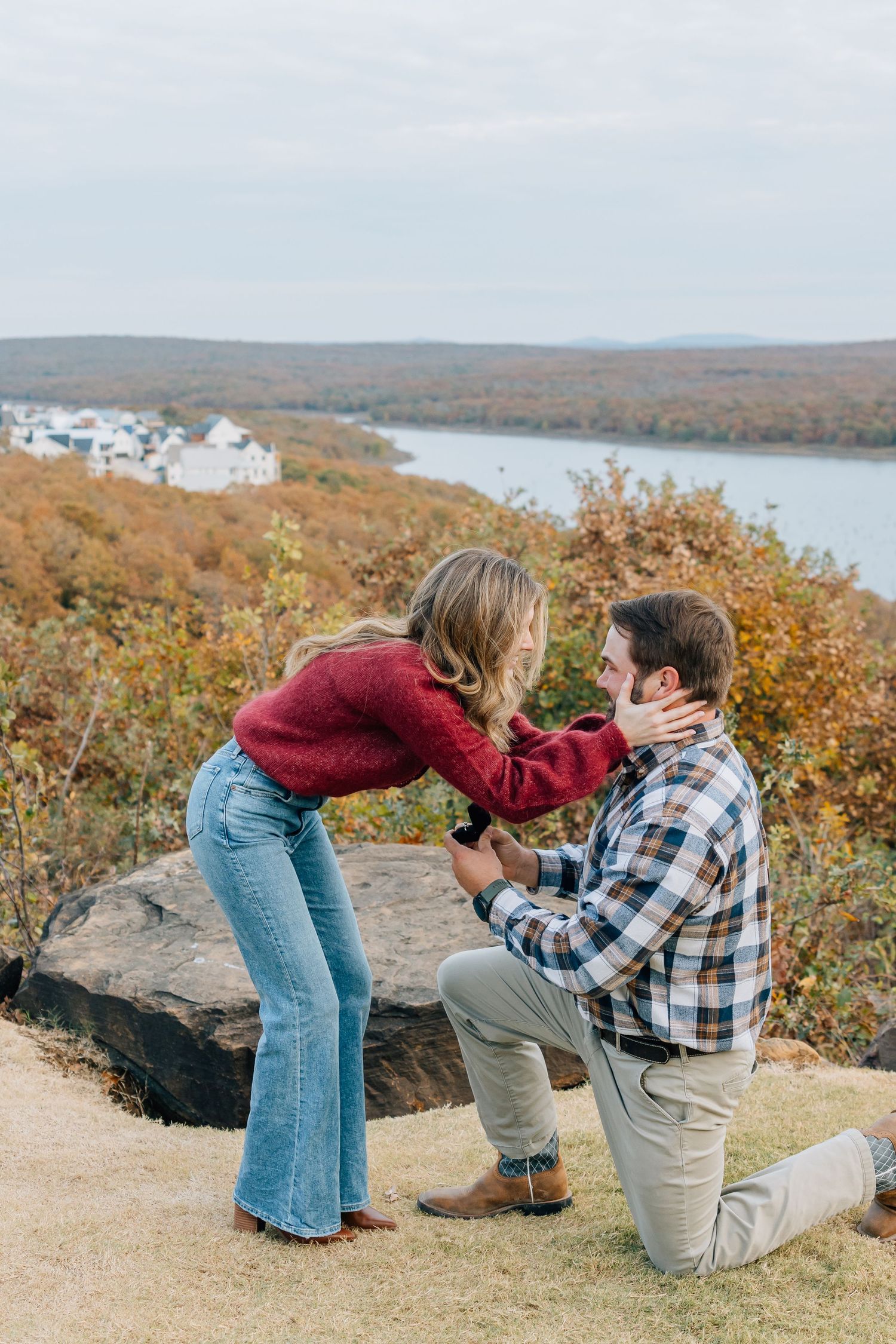 A surprise proposal moment captured on a scenic overlook during autumn.
