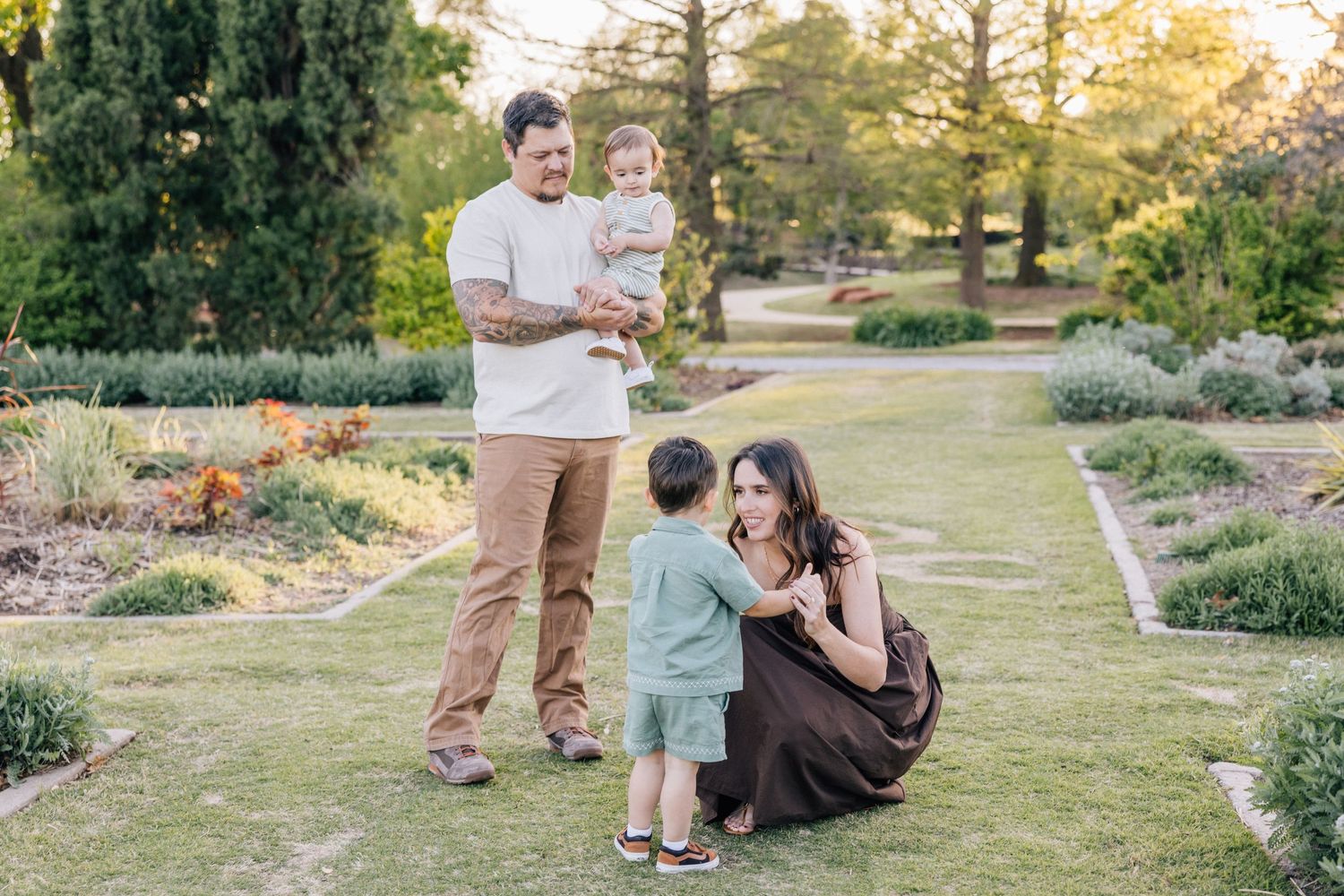 A happy group enjoying a warm afternoon together in a scenic garden path surrounded by blooming flowers and greenery.